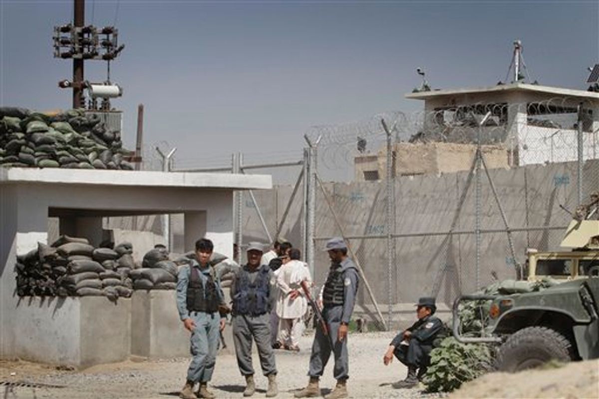 Afghan policemen stand in front of gate of the main prison in Kandahar, south of Kabul, Afghanistan on Monday, April 25, 2011. Taliban insurgents dug a more than 1,050-foot (320-meter) tunnel underground and into the main jail in Kandahar city and whisked out more than 450 prisoners, most of whom were Taliban fighters, officials and the insurgents said Monday. (AP Photo/Allauddin Khan)  (AP)