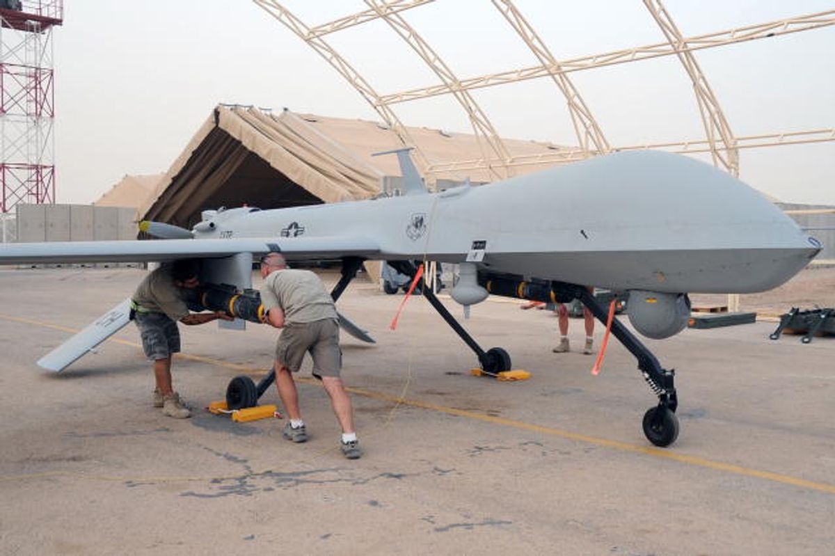 Shilo Thompson and Brandon Walker, both aircraft mechanics with the 361st Expeditionary Reconnaissance Squadron, load an AFM-114 Hellfire missile onto an MQ-1B Predator unmanned aerial vehicle at Ali Air Base, Iraq, on July 9, 2008.  The Predator provides integrated and synchronized close air combat operations for intelligence, surveillance and reconnaissance purposes.  DoD photo by Tech. Sgt. Sabrina Johnson, U.S. Air Force.  (Released) (407th Air Expeditionary Group Pu)