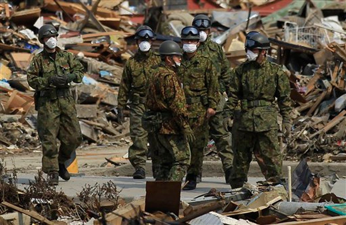 Members of the Japan Ground Self-Defense Force gather to search the victims of the March 11 earthquake and tsunami devastated area in Kesennuma, Miyagi Prefecture, northern Japan, Saturday, April 2, 2011. (AP Photo/Eugene Hoshiko) (AP)