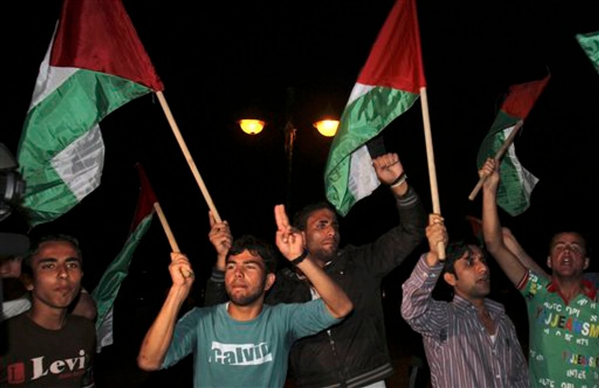 Palestinians wave flags and chant slogans in support of a reconciliation between the rival Fatah and Hamas movements, in Gaza City, Wednesday, April 27, 2011. Palestinians have reached initial agreement on reuniting their rival governments in the West Bank and Gaza, officials from both sides said Wednesday, a step that would remove a main obstacle in the way of peace efforts with Israel. (AP Photo/Adel Hana)   (AP)