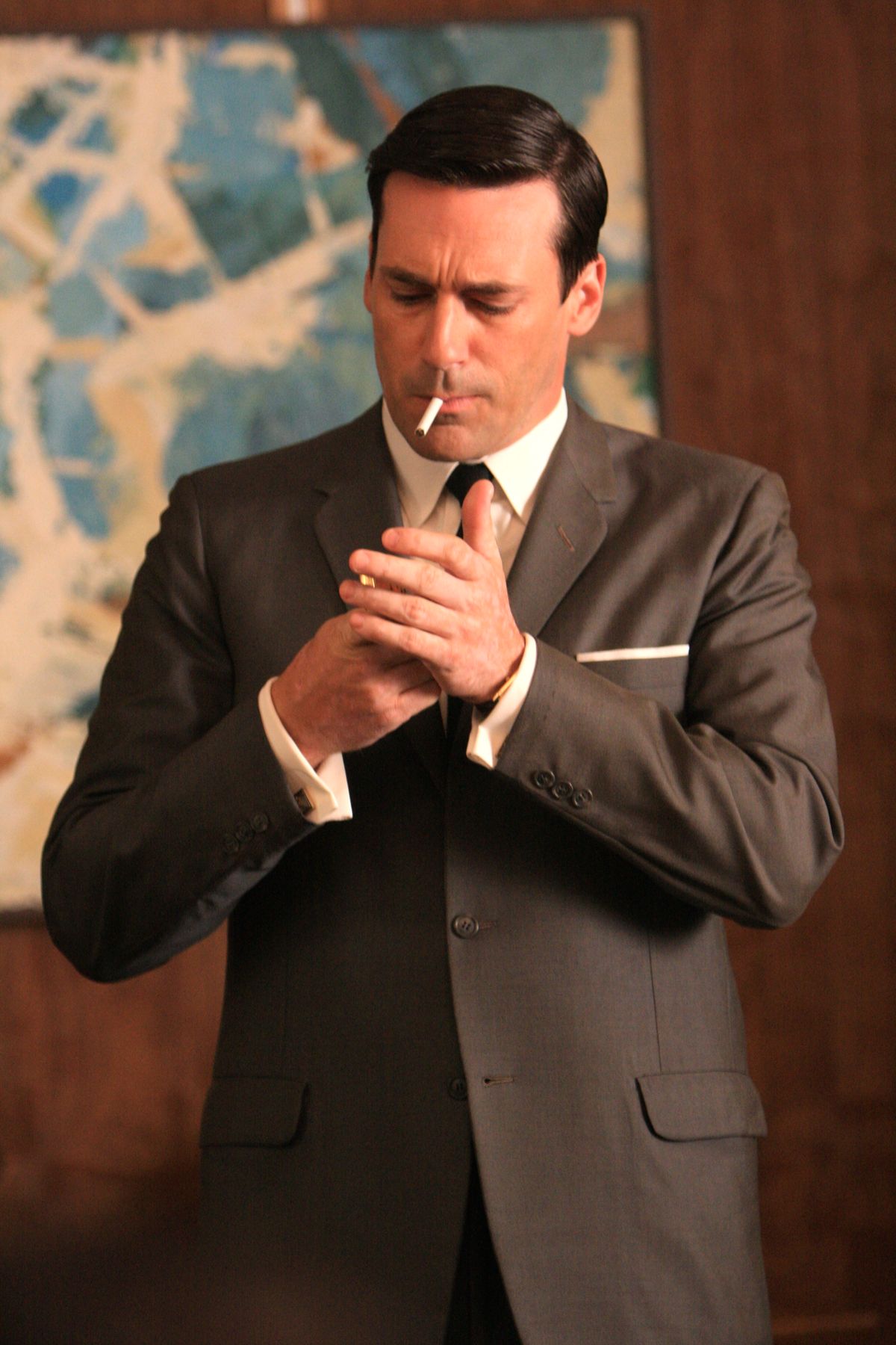 E02MadMenB - For Connors - Don Draper (Jon Hamm) lights up in the office during a meeting at Sterling Cooper. Image credit - Rainbow Media. Maximum width 72 picas at 200 dpi. 10/29/08 (Rainbow Media)