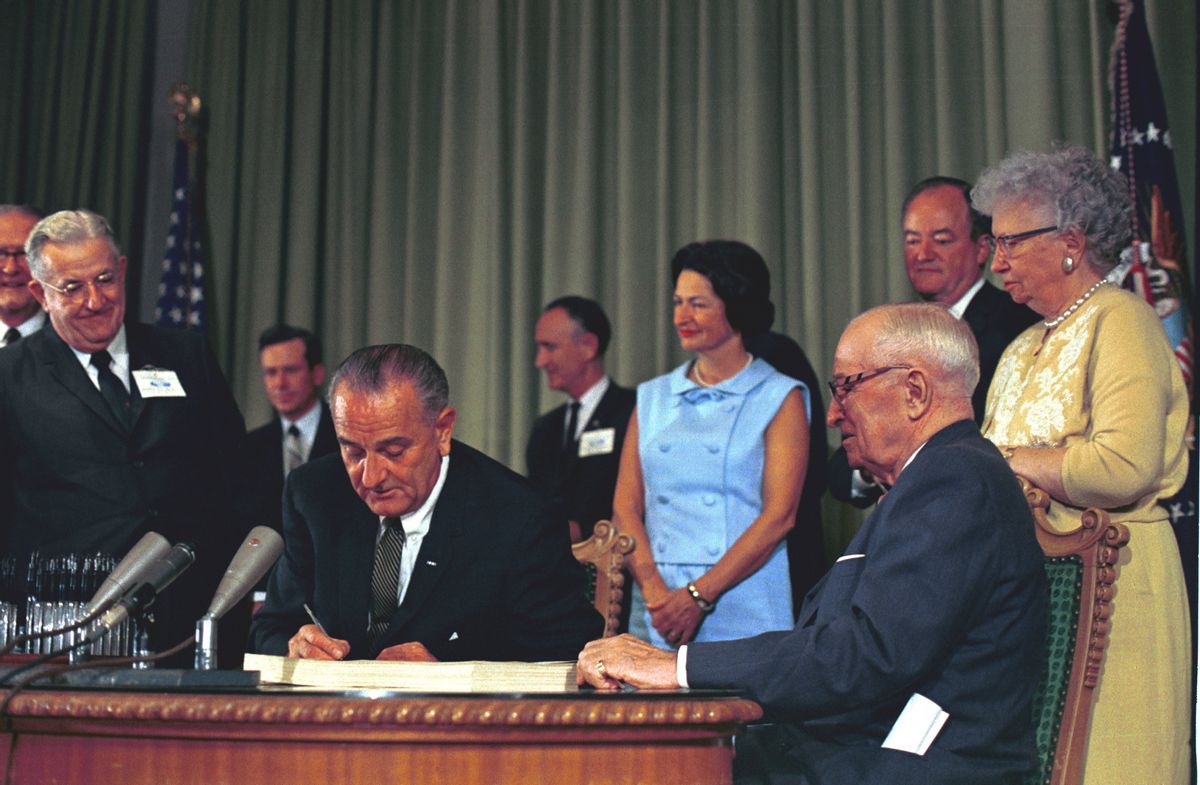Signing of the Medicare Bill July 30, 1965: Left to right, President Lyndon B. Johnson, Lady Bird Johnson, President Harry S. Truman, Vice President Hubert Humphrey, Bess Truman
   