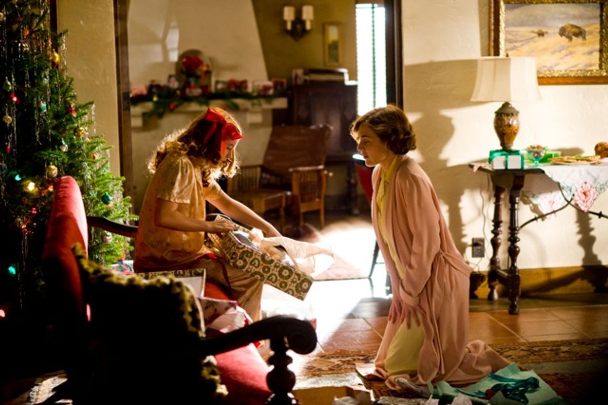 Veda (Morgan Turner) opens a present from her mother Mildred (Kate Winslet) in "Mildred Pierce."