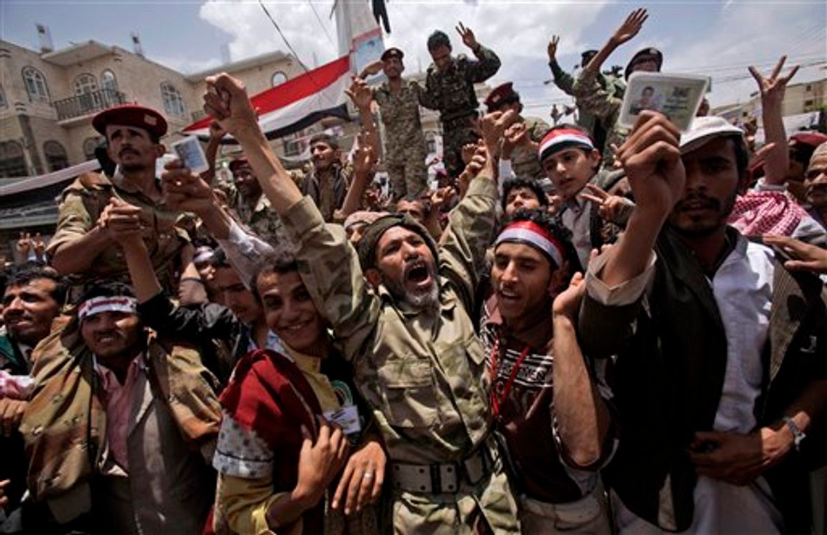 A Yemeni army officer, center, reacts as he and other officers join  anti-government protestors in a demonstration demanding the resignation of  of Yemeni President Ali Abdullah Saleh, in Sanaa, Yemen, Sunday, April 24, 2011. Yemen's embattled president agreed to a proposal by Gulf Arab mediators to step down within 30 days and hand power to his deputy in exchange for immunity from prosecution, a major about-face for the autocratic leader who has ruled for 32 years. (AP Photo/Muhammed Muheisen) (AP)
