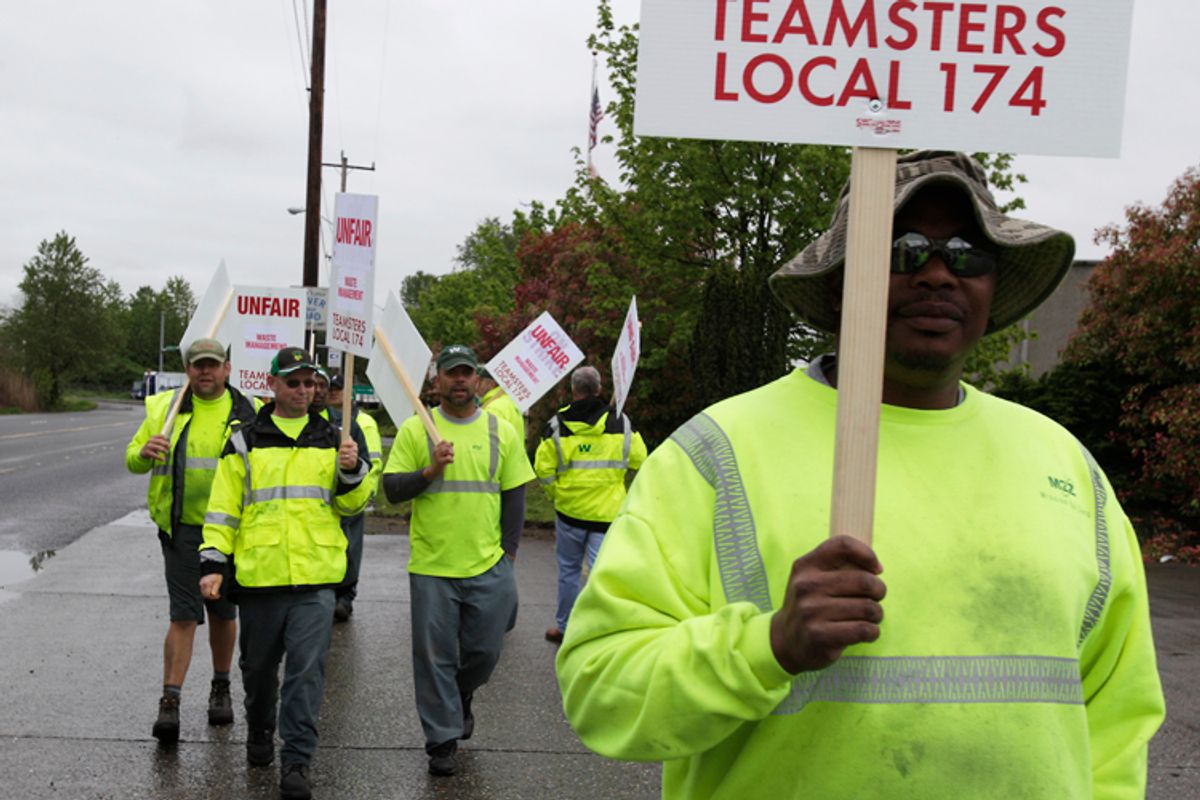 Workers form a picket line at a Waste Management Inc. facility in Seattle, Wednesday, April 21, 2010. Seattle-area garbage workers represented by Teamsters union Local 174 went on strike Wednesday morning. (AP Photo/Ted S. Warren)   (Ted S. Warren)