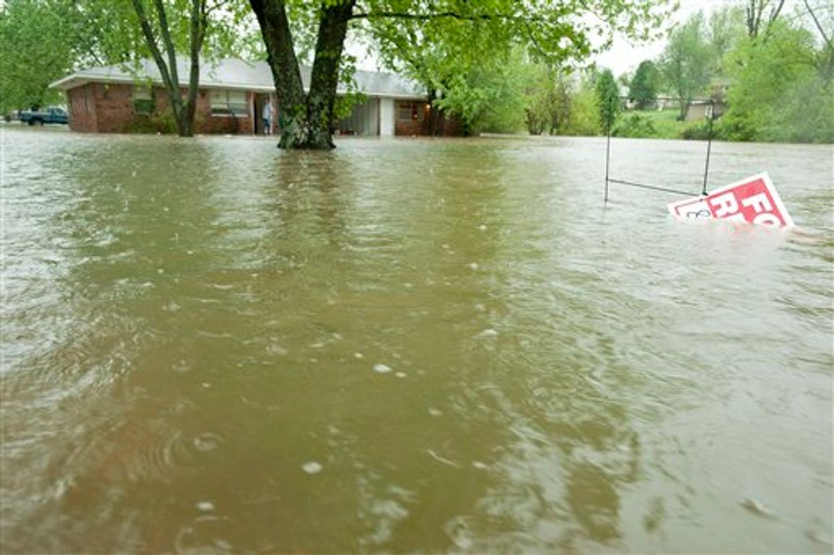 Water from a nearby creek begins to rise around a home on 54th Street on Monday, April 25, 2011, in Fayetteville, Ark. Much of Northwest Arkansas was hit with heavy rain and flash floods. (AP Photo/Beth Hall)    (AP)