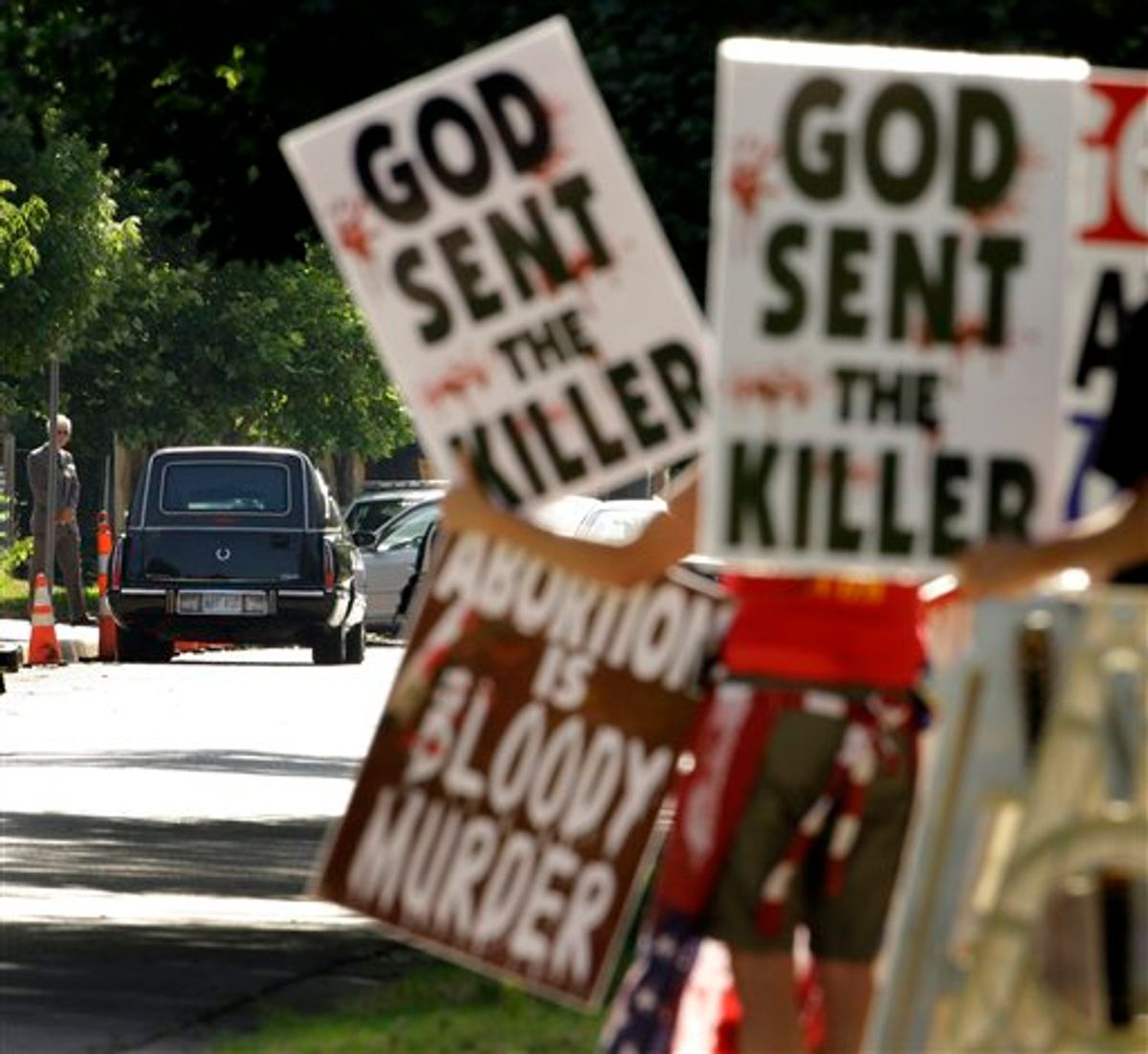 FILE - In this June 6, 2009 file photo, protesters from Rev. Fred Phelps' Westboro Baptist Church demonstrate during funeral services for Dr. George Tiller at College Hill United Methodist Church in Wichita, Kan. In an 8-1 ruling, the U.S. Supreme Court ruled the group's protests were protected by the First Amendment. The father of a Marine killed in Iraq sued after they picketed his son's 2006 funeral service.(AP Photo/Charlie Riedel, File) (AP)