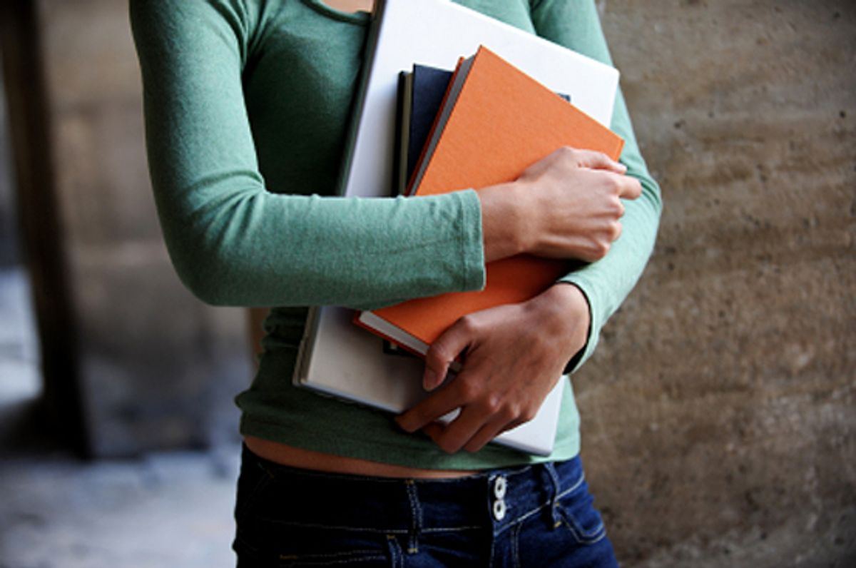Close up of a female university student holding books and a laptop
[url=http://www.istockphoto.com/file_search.php?action=file&amp;lightboxID=4140694][img]http://www.erichood.net/edubanner.jpg[/img][/url] (Eric Hood)