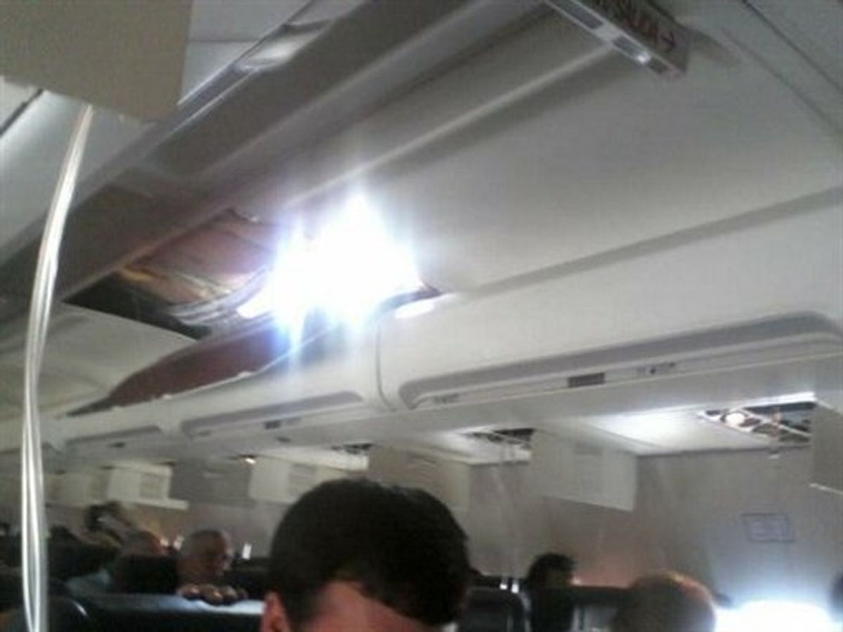 In this photo provided by passenger Joshua Hardwicke, shows a cell phone image of an apparent hole in the cabin on a Southwest Airlines aircraft Friday, April 1, 2011 as it makes an emergency decent into Yuma, Ariz. Authorities say the flight from Phoenix to Sacramento, Calif., was diverted to Yuma due to rapid decompression in the plane.  FAA spokesman Ian Gregor says the cause of the decompression isn't immediately known. But passengers aboard the plane say there was a hole in the cabin and that forced an emergency landing. (AP photo/Joshua Hardwicke) NO SALES (AP)