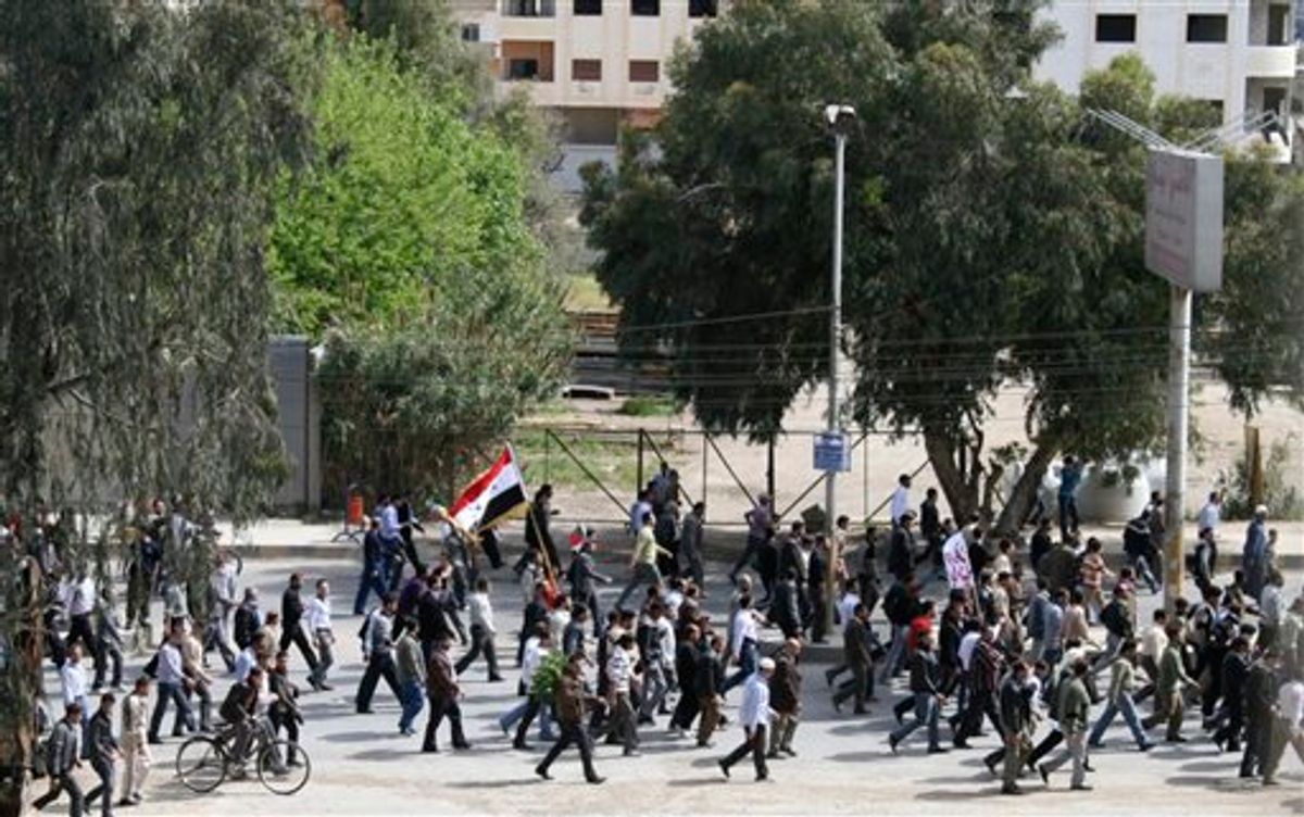 Syrian anti-government protesters march during a demonstration following Friday prayers near Damascus, Syria, Friday, April 22, 2011. Security forces fired live bullets and tear gas Friday at tens of thousands of people shouting for freedom and democracy in several areas across the country. (AP Photo) (AP)