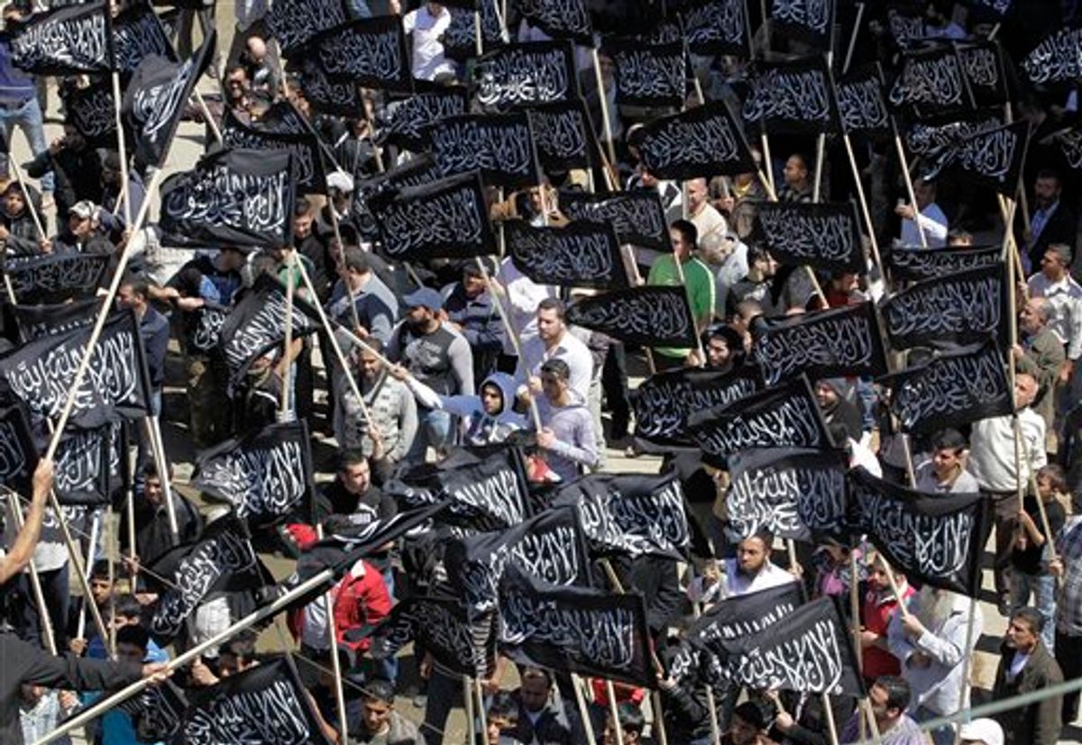 Supporters of an Islamic group wave their party flags as they protest against the Syrian regime, in the northern city of Tripoli, Lebanon, on Friday April 22, 2011. The demonstration in support of the "Syrian people" was called for by the Tahrir Party. It was not granted a license from the interior ministry. Syrian security forces have launched a deadly crackdown on demonstrations that started last month, killing more than 200 people. (AP Photo/Hussein Malla) (AP)