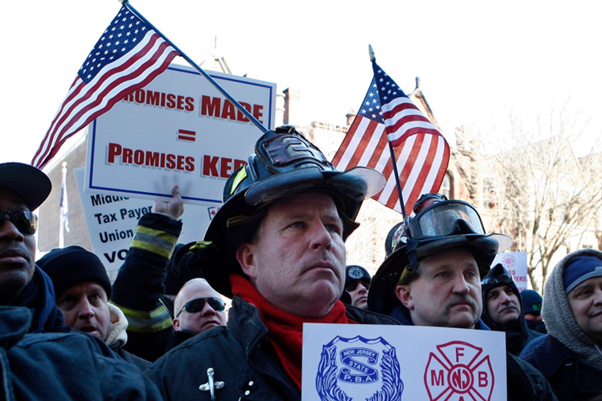 Elizabeth Fire Department firefighters Rick Maliniak, center left, and Andy Socha have American Flags stuck in their helmets as they stand with other firefighters and police officers and their supporters in a large gathering outside the Statehouse Thursday, March 3, 2011, in Trenton, N.J., during a rally to protest staff cuts and promote public safety. They say budget cuts and layoffs have thinned their ranks to unsafe levels. The rally is the second at the Statehouse in a week. The AFL-CIO sponsored a unity rally for Wisconsin state workers Friday. They are fighting limits on their right to collectively bargain. (AP Photo/Mel Evans) (Mel Evans)