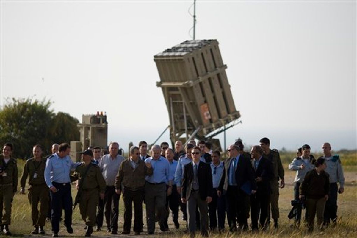 Israeli Prime Minister Benjamin Netanyahu, center right, and Defense Minster Ehud Barak, center left, visit the Iron Dome missile defense system, background, deployed in Ashkelon, southern Israel, Sunday, April 10, 2011. A senior member of Gaza's ruling Hamas movement on Sunday made a rare appeal to the Israeli public to halt escalating cross-border fighting, telling an Israeli radio station in fluent Hebrew that Hamas is ready to stop its rocket fire if Israel ends its attacks on Gaza. (AP Photo/Ariel Schalit)  (AP)