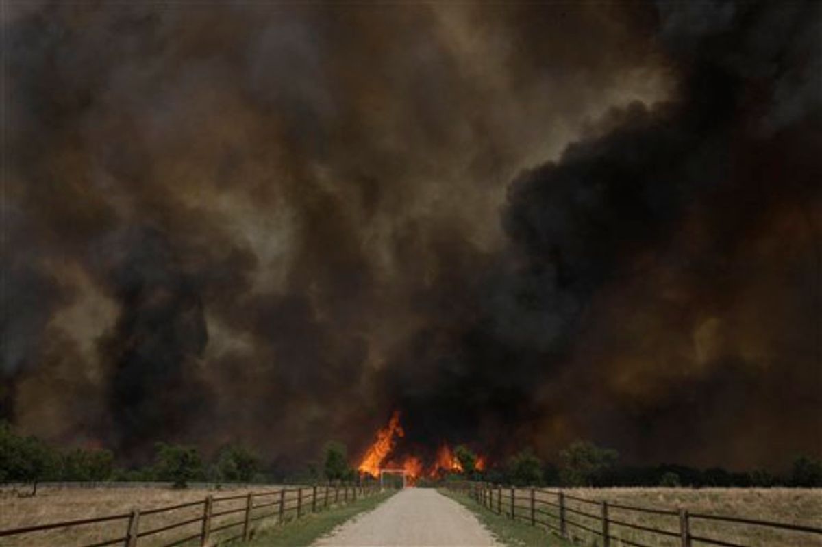 Smoke rises from an uncontrolled wildfire burning near Possum Kingdom, Texas, Tuesday, April 19, 2011.  (AP Photo/LM Otero)  (AP)