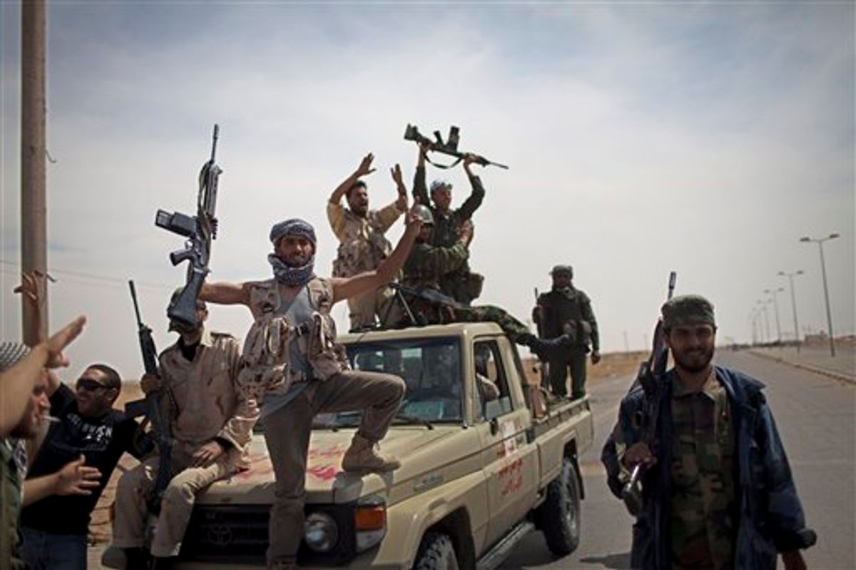 A rebel fighters celebrate after coming back from the front line against  Moammar Gadhafi's forces, Ajdabia, Libya, Monday, May 9, 2011.  (AP Photo/Rodrigo Abd) (AP)