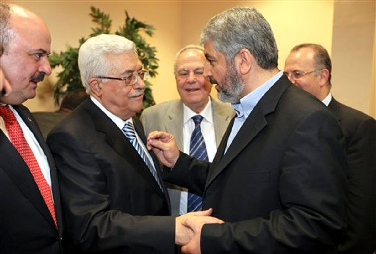 In this photo released by the Hamas Media Office, Palestinian President Mahmoud Abbas, center-left, and Hamas leader Khaled Mashaal, center-right, shake hands at a ceremony in Cairo, Egypt Wednesday, May 4, 2011. Rival Palestinian factions Fatah and Hamas on Wednesday proclaimed a landmark, Egyptian-mediated reconciliation pact aimed at ending their bitter four-year rift, at a declaration ceremony in the Egyptian capital Cairo. (AP Photo/Hamas Media Office) ** EDITORIAL USE ONLY, NO SALES **  (AP)