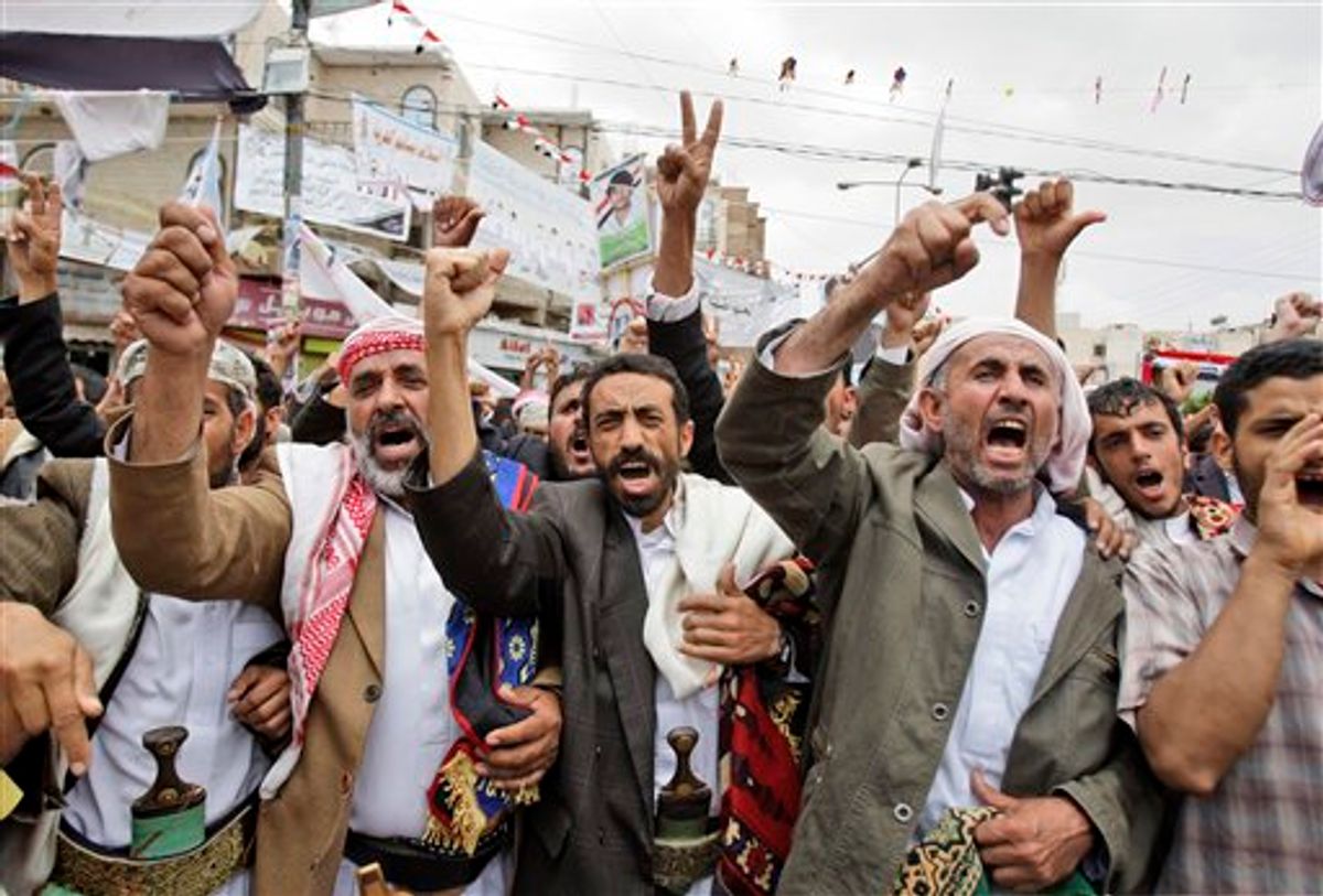 Anti-government protestors, shout slogans during a demonstration demanding the resignation of Yemeni President Ali Abdullah Saleh, in Sanaa, Yemen, Saturday, May 28, 2011. Fighting that rocked Sanaa for the past five days spread beyond the capital on Friday as Yemeni tribesmen opposed to the rule of President Ali Abdullah Saleh seized a Republican Guard military camp in battles that left dozens dead and prompted airstrikes by government warplanes, according to a tribal leader. (AP Photo/Hani Mohammed) (AP)