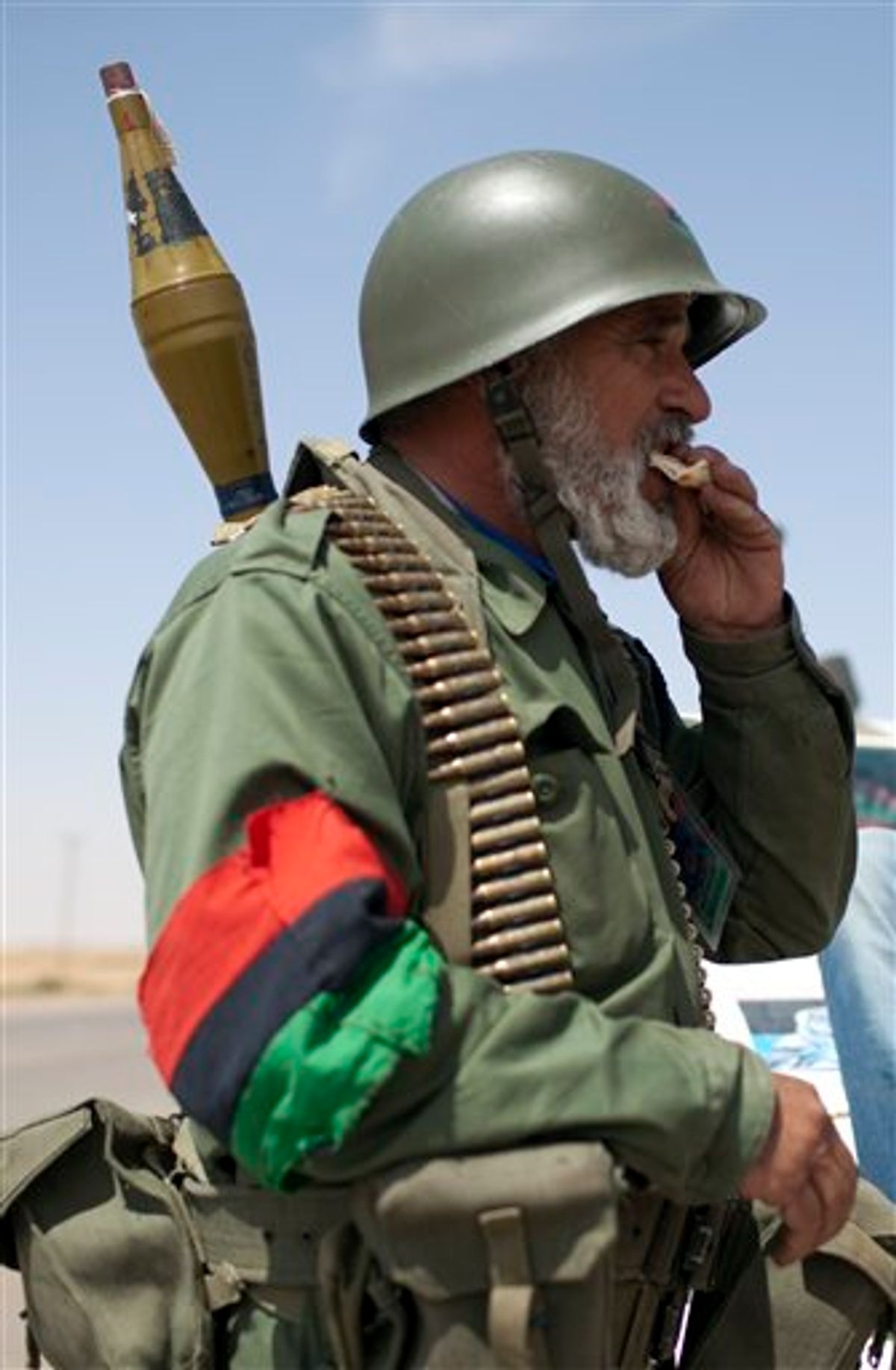 A rebel fighter eats bread in a checkpoint in Ajdabiya, Libya, Monday, May 9, 2011.  (AP Photo/Rodrigo Abd) (AP)