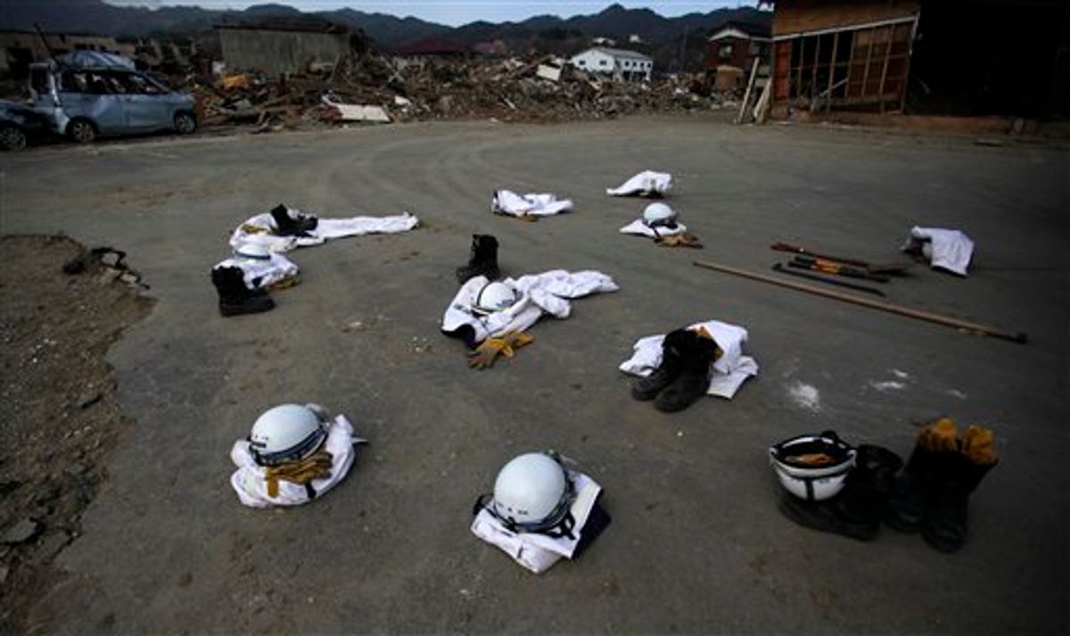 Police officers' protective suits, boots and helmets are placed on the ground while they rest after their recovery operation shift in the area destroyed by the March 11 earthquake and tsunami in Kesennuma,  Miyagi Prefecture, northeastern Japan, Saturday, May 7, 2011.  (AP Photo/Junji Kurokawa)  (AP)