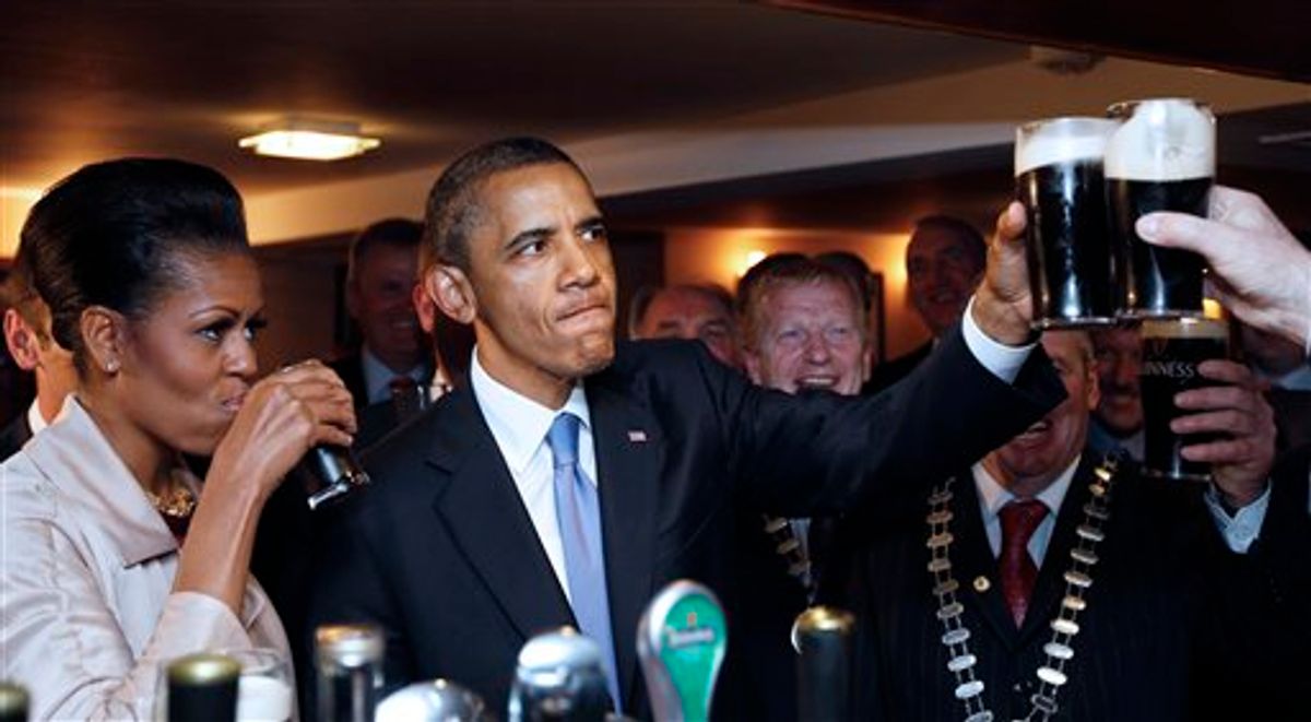U.S. President Barack Obama and first lady Michelle Obama drink Guinness beer as they meet with local residents at Ollie Hayes pub in Moneygall, Ireland, the ancestral homeland of his great-great-great grandfather, Monday, May 23, 2011. (AP Photo/Charles Dharapak) (AP)