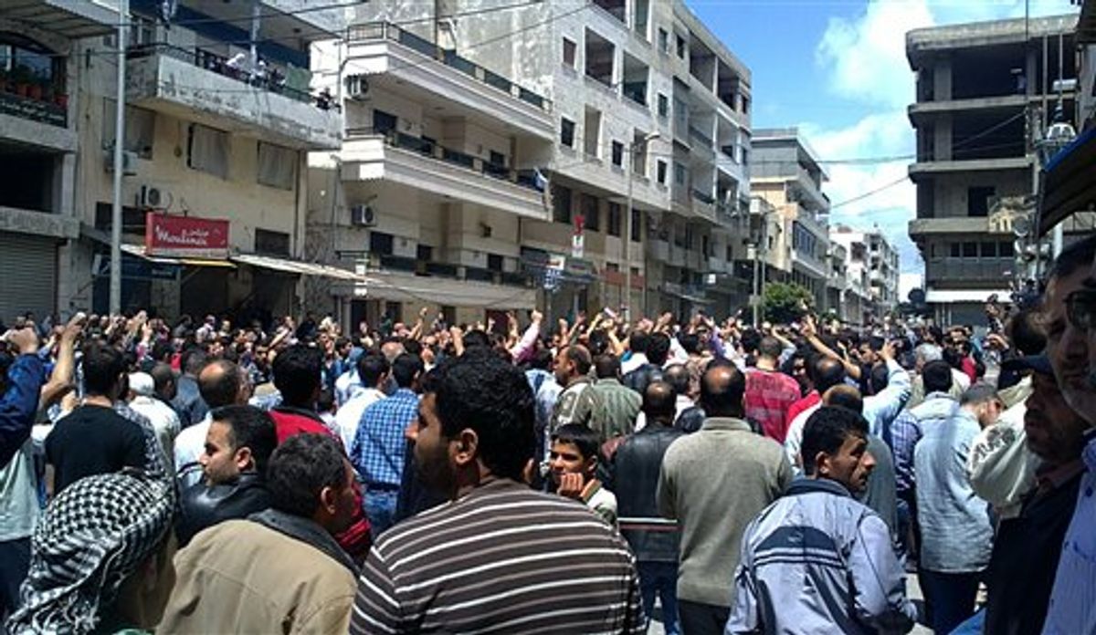 In this citizen journalism image made on a mobile phone and acquired by the AP, Syrian anti-government protesters shout slogans as they gather in the coastal town of Banias, Syria, Friday, May 6, 2011. Syrian security forces opened fire on protesters Friday, killing at least 16 people as thousands joined demonstrations across the country calling for an end to President Bashar Assad's regime, witnesses and activists said. (AP Photo) (AP)
