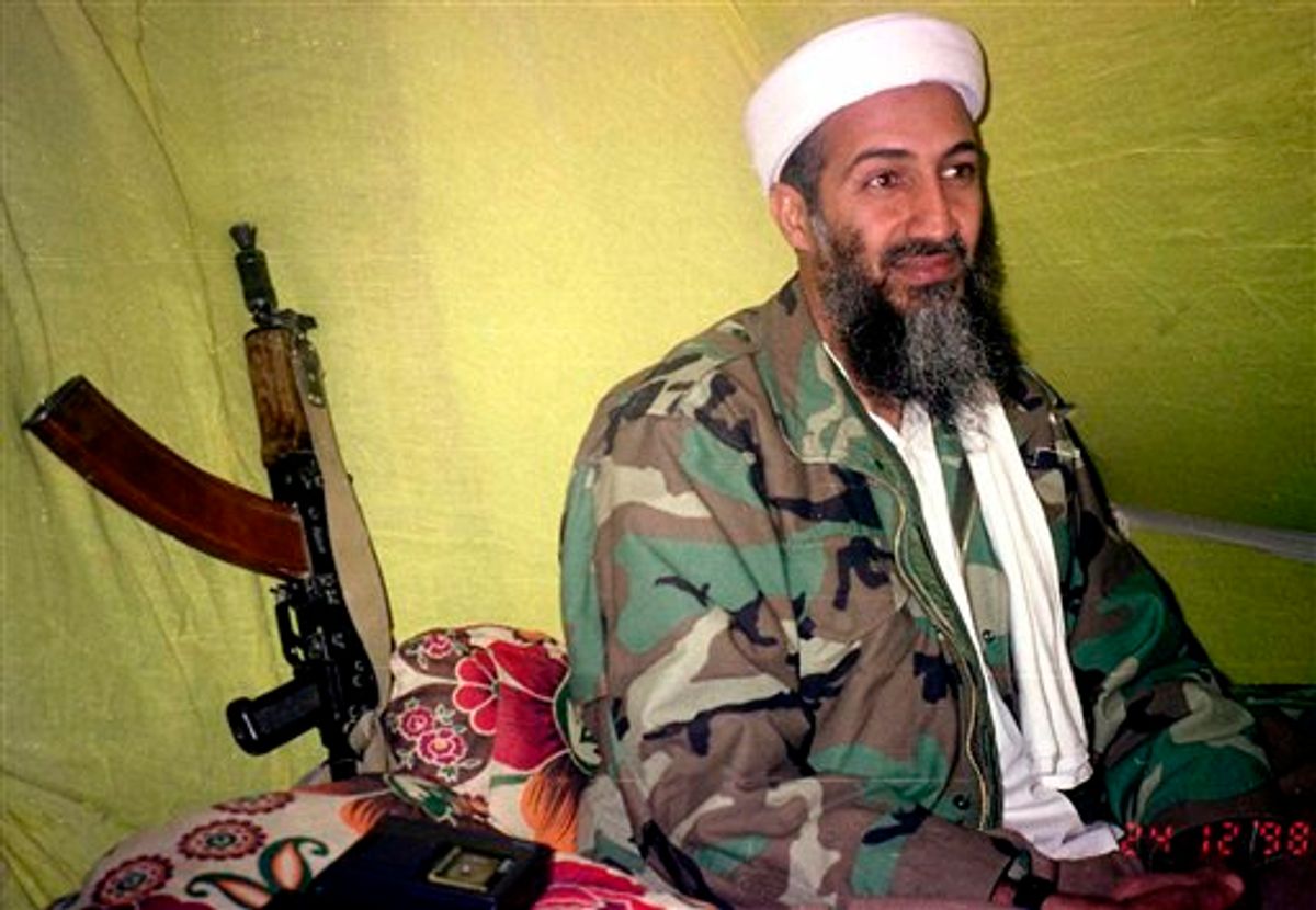 FILE - In this Dec. 24, 1998 file photo, Muslim militant and al-Qaida leader Osama Bin Laden speaks to a selected group of reporters in mountains of Helmand province in southern Afghanistan. The Americans who raided bin Laden's lair met far less resistance than the Obama administration described in the aftermath, according to its latest account. The commandos encountered gunshots from only one man, whom they quickly killed, before sweeping the house and shooting others, who were unarmed, a senior defense official said. (AP Photo/Rahimullah Yousafzai, File) (AP)
