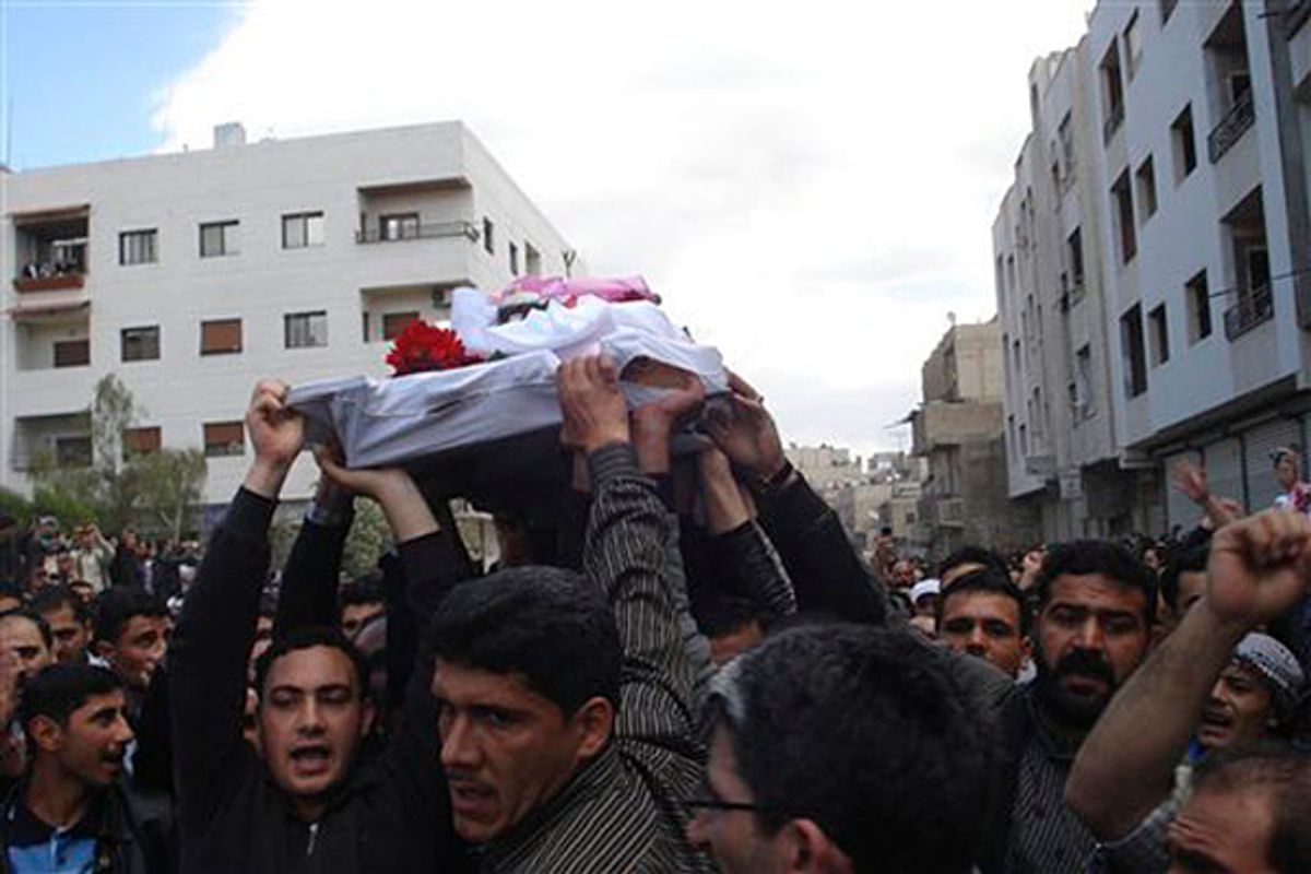 In this citizen journalism image made on a mobile phone and acquired Saturday April 23, 2011, by The AP, Syrian anti-government protesters carry the coffin of an activist who was killed on Friday during his funeral procession in Quaboun near Damascus, Syria, Saturday, April 23, 2011.  Syrian security forces fired on tens of thousands of mourners during funeral processions Saturday, killing several people following the deadliest day of the uprising against authoritarian President Bashar Assad. (AP Photo) (Str)