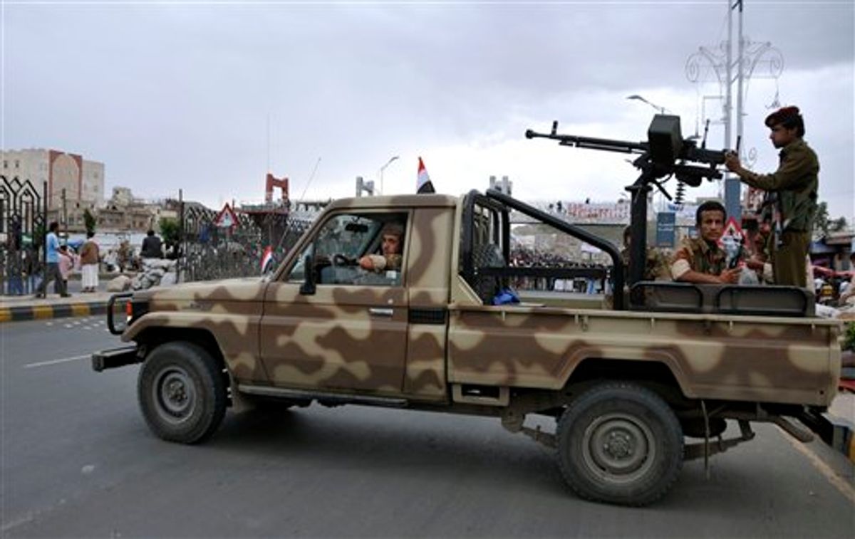 Yemeni army soldiers seen in their vehicle on guard at a checkpoint in Sanaa, Yemen, Wednesday, May 25, 2011. Yemen's embattled President Ali Abdullah Saleh issued messages of hard-line defiance Wednesday even as intense battles raged in the heart of the capital for a third day, saying he will not step down or allow the country to become a "failed state." (AP Photo/Mohammed Al-Sayaghi) (AP)