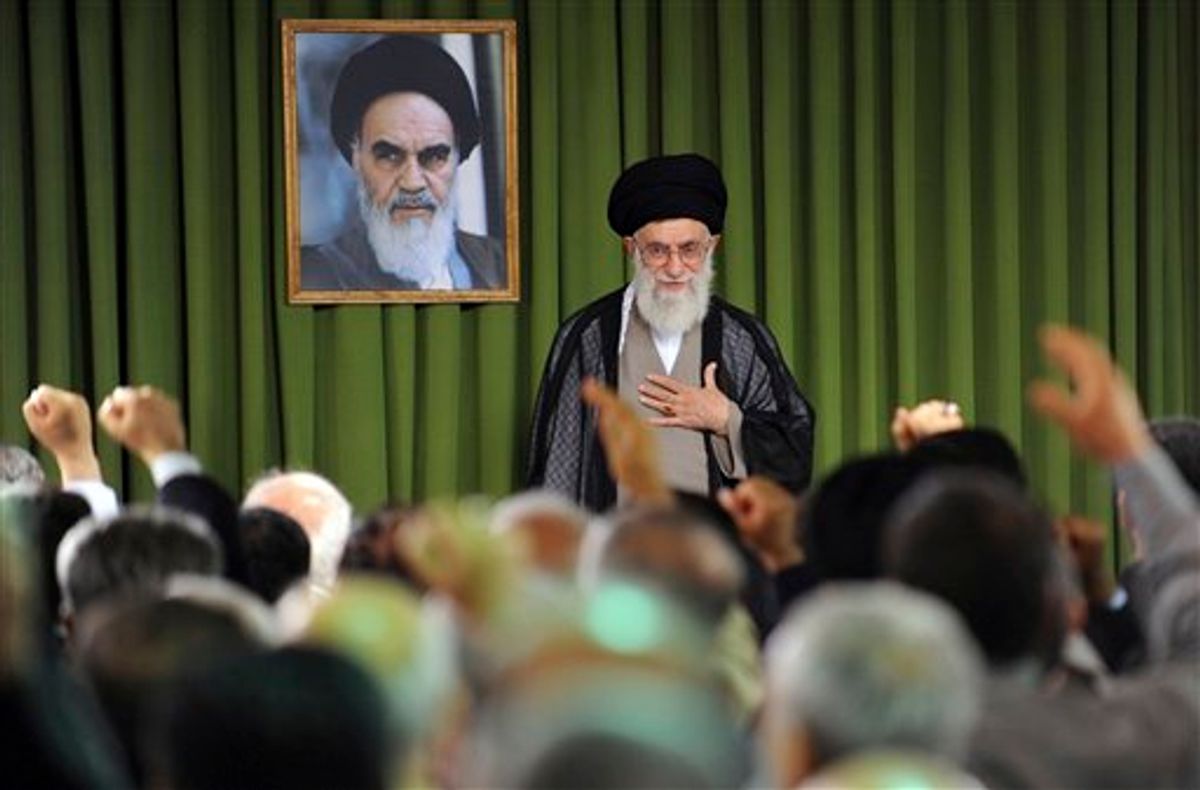 In this photo released by the official website of the Iranian supreme leader's office, Iranian supreme leader Ayatollah Ali Khamenei, places his hand on his heart as a gesture of respect to the lawmakers, foreground, as some of them clench their fists while chanting slogans, at the start of their meeting, in Tehran, Iran, Sunday, May 29, 2011. A picture of the late revolutionary founder Ayatollah Khomeini hangs at rear. (AP Photo/Office of the Supreme Leader)  EDITORIAL USE ONLY  NO SALES  (AP)