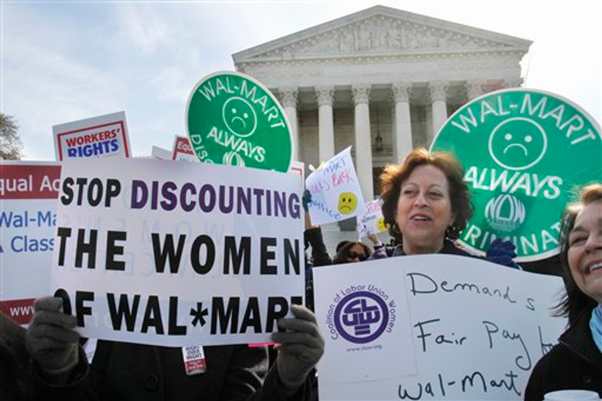 In this March 29, 2011 photo, Carol Rosenblatt of Washington, right, and others, take part in rally outside the Supreme Court in Washington, in support of the plaintiffs in a case of women employees against Wal-Mart 