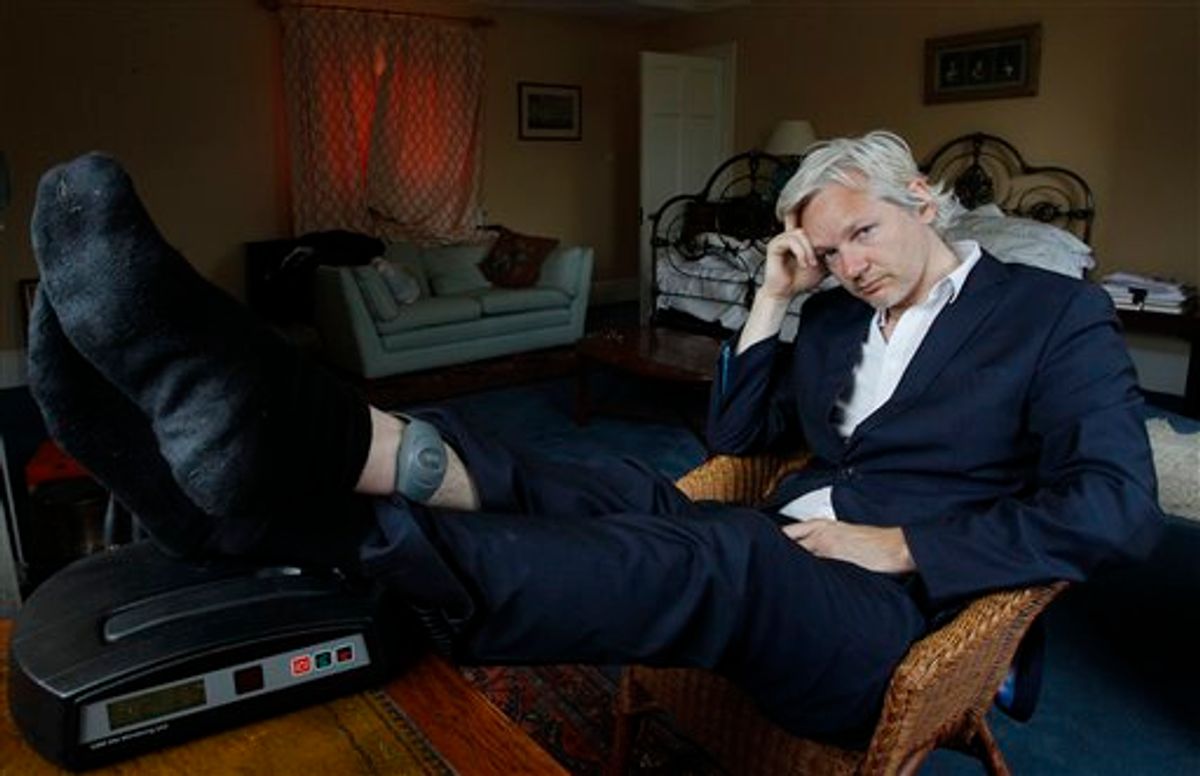 WikiLeaks founder Julian Assange is seen with his ankle security tag at the house where he is required to stay, near Bungay, England, Wednesday, June 15, 2011.  Assange says his house arrest over sex allegations is hampering the work of the secret-spilling site, and his supporters accuse Britain of spying on him.  The 39-year-old Australian has spent six months at a supporter's rural estate as he fights extradition to Sweden, where he is accused of the rape and sexual assault of two women.(AP Photo/Kirsty Wigglesworth) (AP)