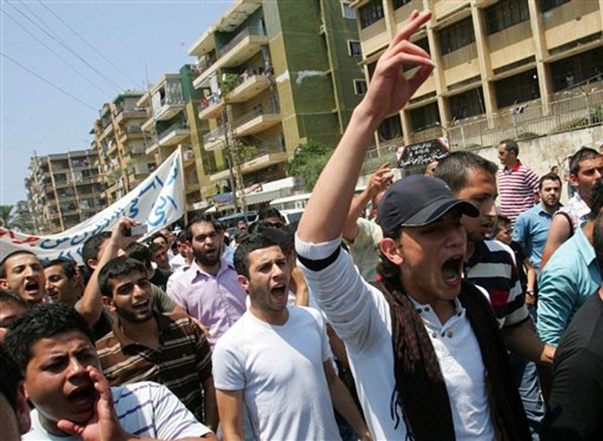 Lebanese anti-Syrian regime protesters shout slogans during a demonstration to support the Syrian demonstrators who protest in Syria against Bashar Assad's regime, in Tripoli, northern Lebanon, Friday July 1, 2011. Hundreds of thousands of protesters flooded cities around Syria on Friday in one of the largest outpourings against the regime of President Bashar Assad since the uprisings began more than three months ago. At least six people were killed in various clashes, activists said. (AP Photo) (AP)