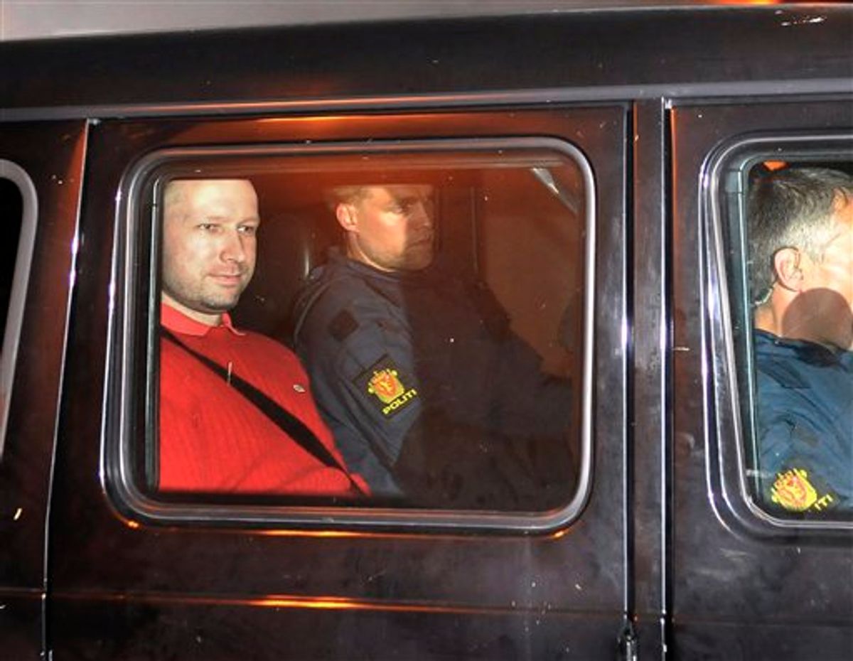 Norway's twin terror attacks suspect Anders Behring Breivik, left, sits in an armored police vehicle after leaving the courthouse following a hearing in Oslo Monday July 25, 2011 where he pleaded not guilty to one of the deadliest modern mass killings in peacetime. The man who has confessed to carrying out a bombing and shooting spree that left 93 people dead in Norway will be held in complete isolation for four weeks after a hearing in which he said his terror network had two other cells.    (AP Photo/Aftenposten/Jon-Are Berg-Jacobsen) NORWAY OUT (AP)