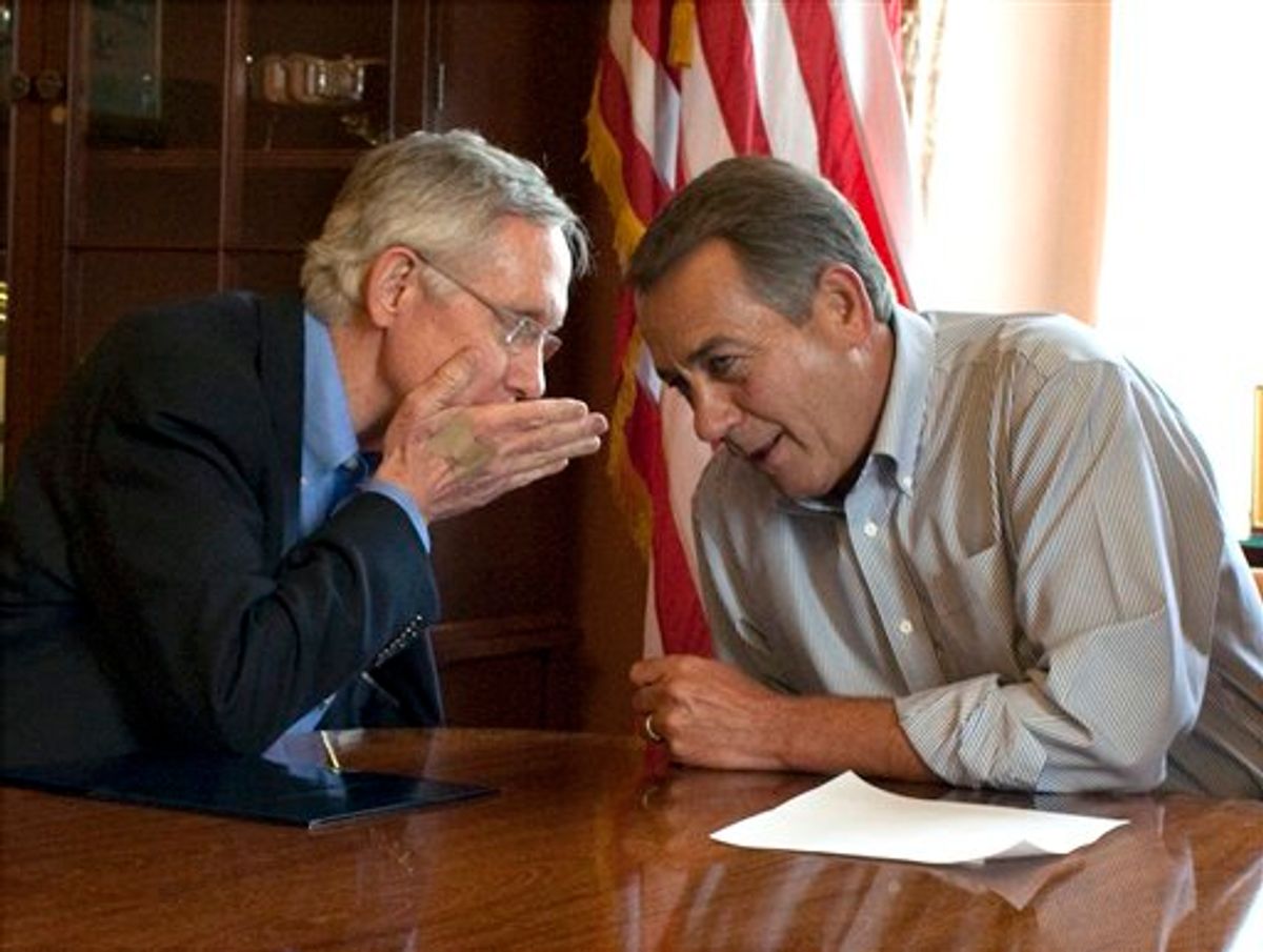 Senate Majority Leader Harry Reid, D-Nev., holds his hand up as he whispers to House Speaker John Boehner, R-Ohio,  during a photo opportunity in the House Speaker's office before a meeting on the debt limit increase on Capitol Hill in Washington on Saturday, July 23, 2011.(AP Photo/Harry Hamburg) (AP)