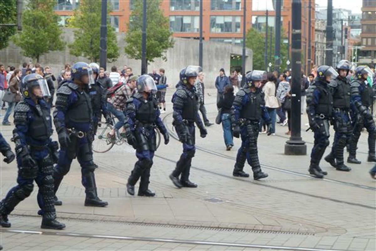 Riot police patrol Manchester city centre after trouble  on Market street  in Manchester city centre, England,  Tuesday Aug. 9, 2011.  Britain began flooding London's streets with 16,000 police officers Tuesday, nearly tripling their presence as the nation feared its worst rioting in a generation would stretch into a fourth night. The violence has turned buildings into burnt out carcasses, triggered massive looting and spread to other U.K. cities.   (AP Photo /  Dave Thompson / PA)  UNITED KINGDOM OUT NO SALES NO ARCHIVE     (AP)