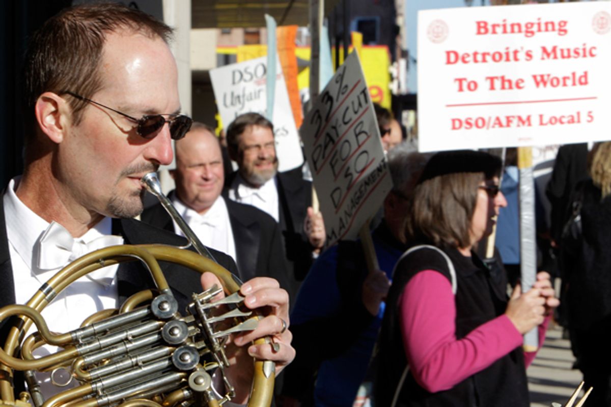 Detroit Symphony Orchestra member Karl Pituch serenades fellow orchestra members walking a picket line outside the Max M. Fisher Music Center in Detroit in October, 2010.