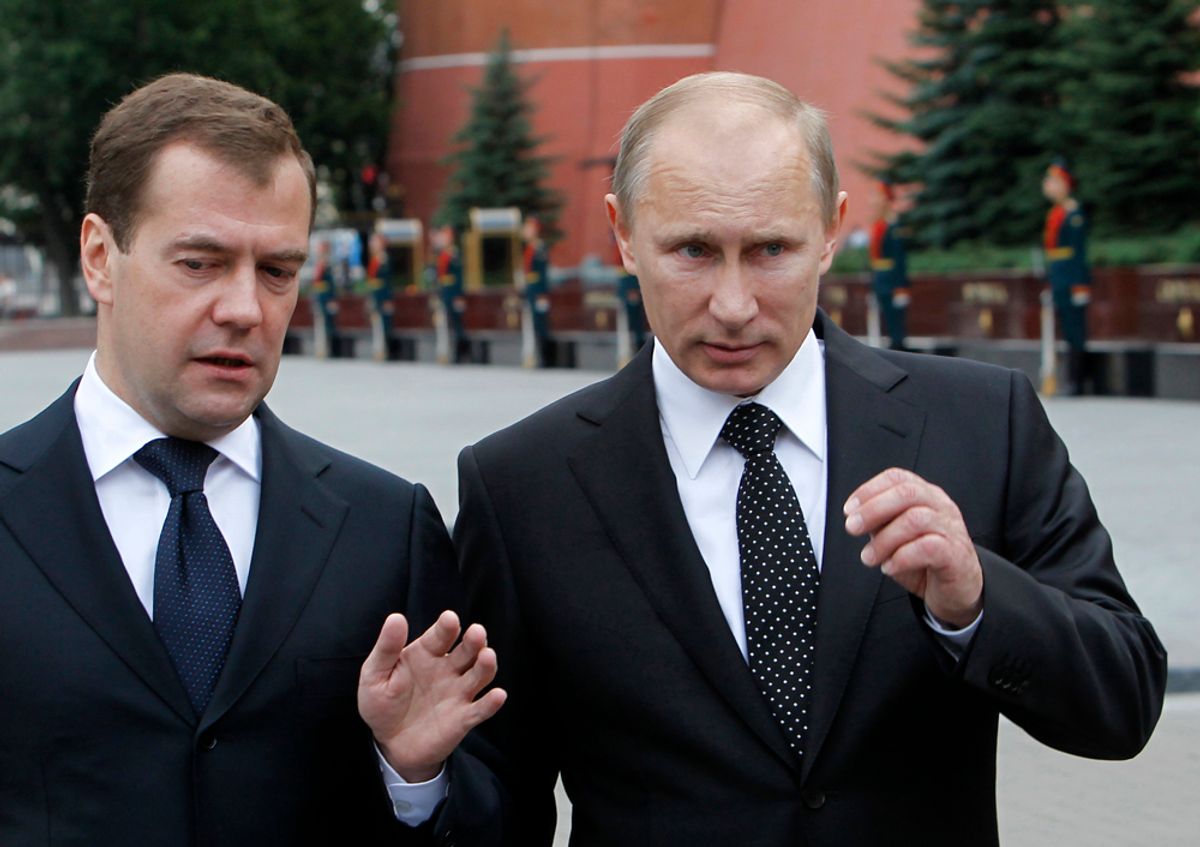 Russian President Dmitry Medvedev (L) and Prime Minister Vladimir Putin talk after a remembrance ceremony at the Tomb of the Unknown Soldier in Moscow, June 22, 2011. Russia marks on Wednesday the 70th anniversary of the start of the Soviet war against Nazi Germany, known to Russians as "The Great Patriotic war".  REUTERS/Dennis Sinyakov  (RUSSIA - Tags: ANNIVERSARY CONFLICT POLITICS)                 (Â© Denis Sinyakov / Reuters)