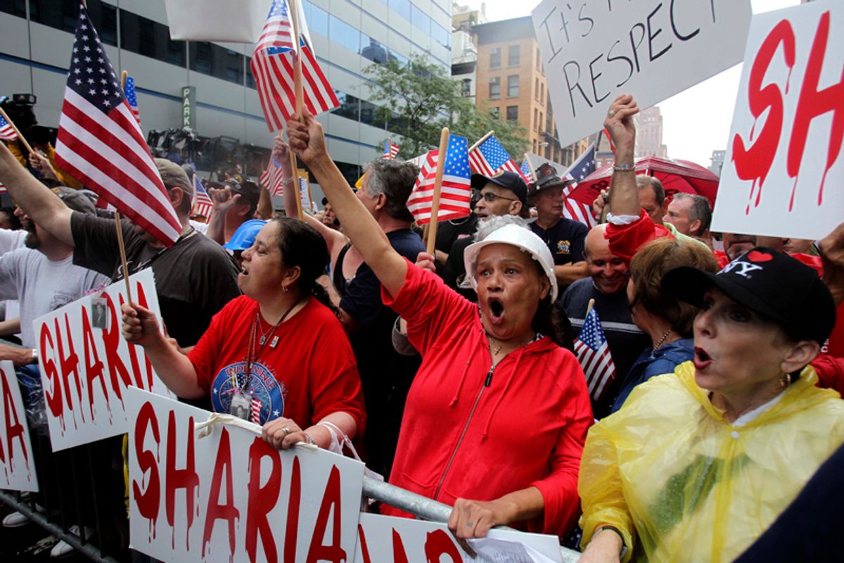 People participate in a rally against a proposed mosque and Islamic community center near ground zero in New York, Sunday, Aug. 22, 2010.  (AP Photo/Seth Wenig) (Seth Wenig)