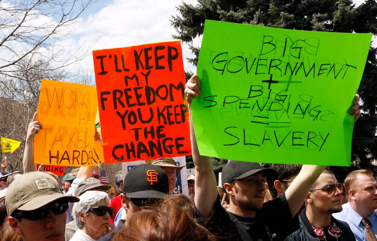People wave signs at a "tea party" protest on the grounds of the Colorado state capitol in Denver April 15, 2009 (Reuters)