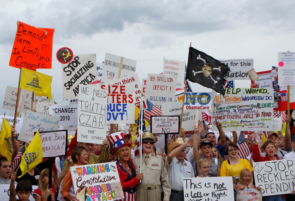 People hold signs during a "tea party" protest in Flagstaff, Arizona August 31, 2009. Organizers say the event is an effort to work against members of Congress who voted for higher spending and taxes. REUTERS/Joshua Lott (UNITED STATES BUSINESS IMAGES OF THE DAY CONFLICT POLITICS)   (Reuters)