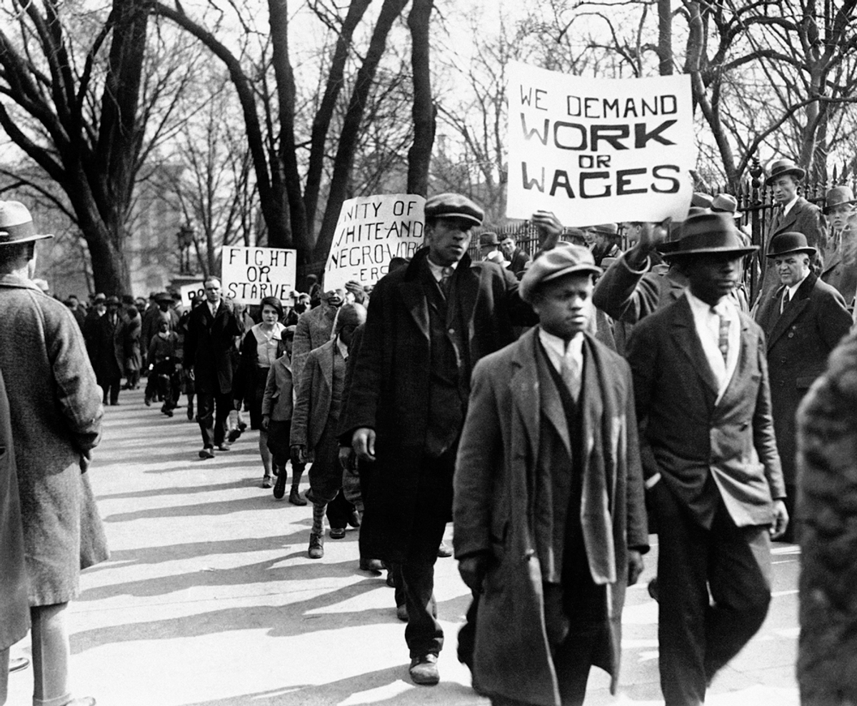 In this March 6, 1930 file photo, groups of unemployed gather in front of the White House before parading in protest in Washington 