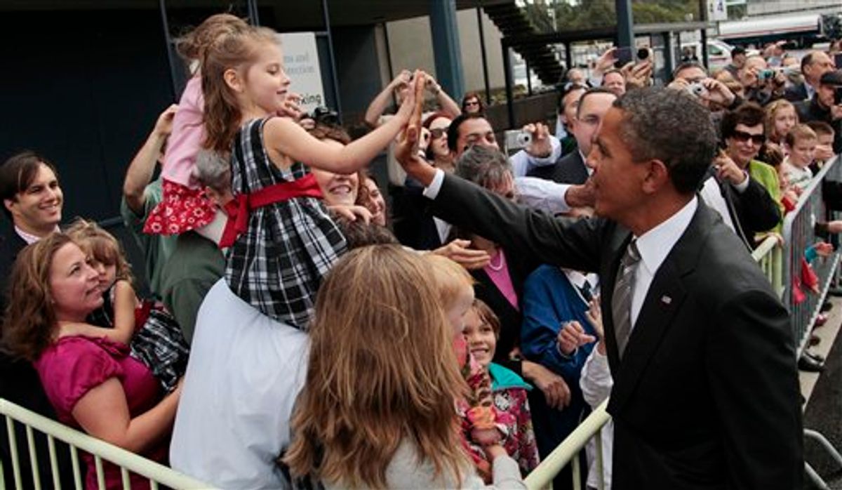 President Barack Obama, right, greets guests on the tarmac during his arrival at King County International Airport/Boeing Field, Sunday, Sept., 25, 2011, in Seattle, Wash.  (AP Photo/Pablo Martinez Monsivais) (AP Photo/Pablo Martinez Monsivais)