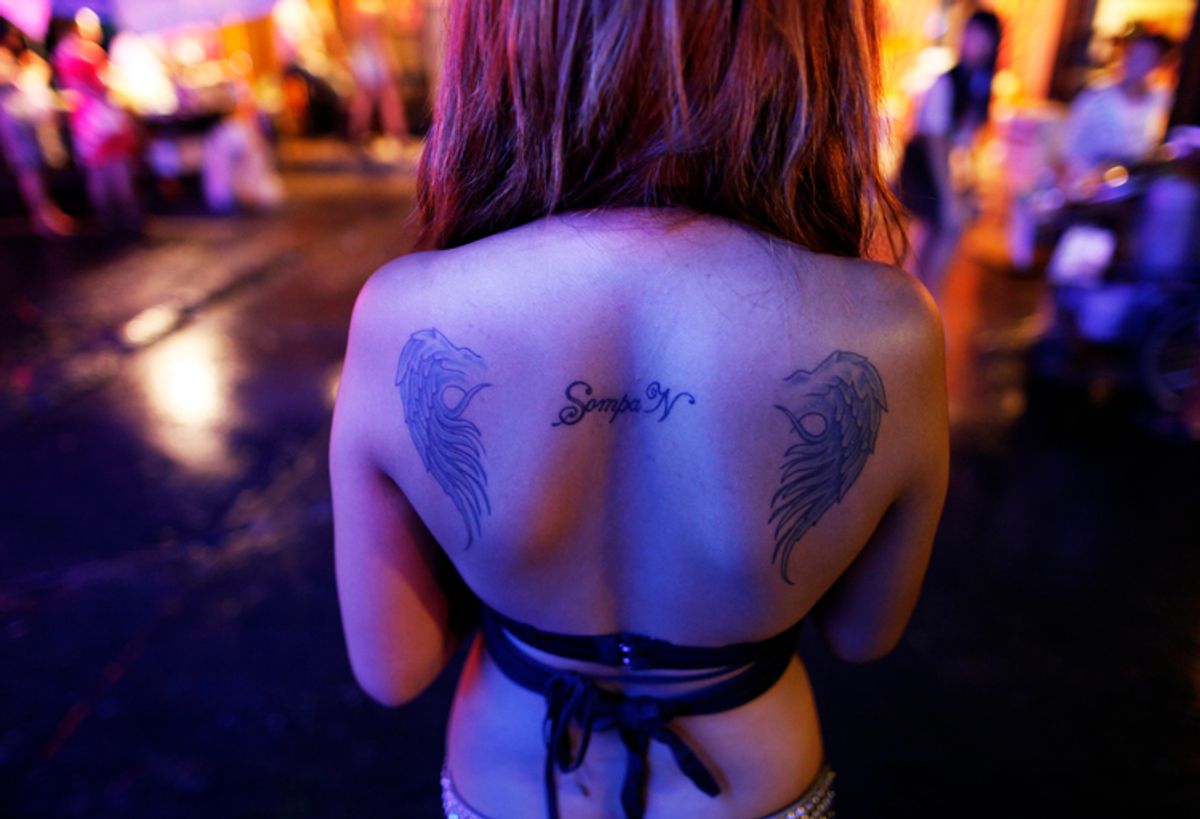 A Thai go-go dancers waits for customers at Bangkok's normally packed Soi Cowboy red-light area just before curfew May 25, 2010. Bar owners and go-go dancers say a night-time curfew in the Thai capital has badly affected their business, with tourist scared off and expatriate customers staying home.   REUTERS/Damir Sagolj (THAILAND - Tags: POLITICS CIVIL UNREST TRAVEL BUSINESS) (Reuters)