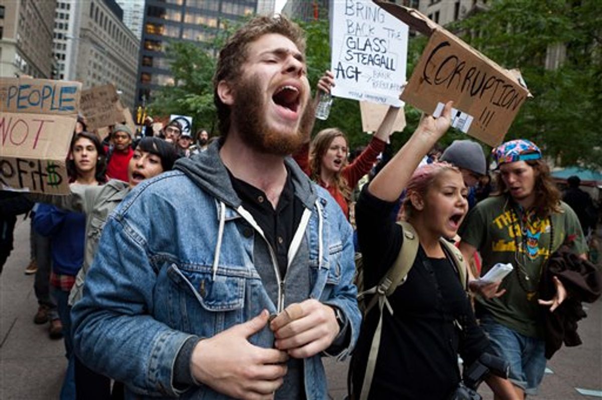 A few hundred demonstrators protesting against corporations march from nearby Zucotti park to Wall Street, Tuesday, Sept. 20, 2011, in the Manhattan borough of New York. The demonstrators, who have been camping overnight in the park since Saturday, have been surrounded by police officers around the clock with at least 12 protestors arrested in recent days. (AP Photo/John Minchillo) (AP Photo/John Minchillo)