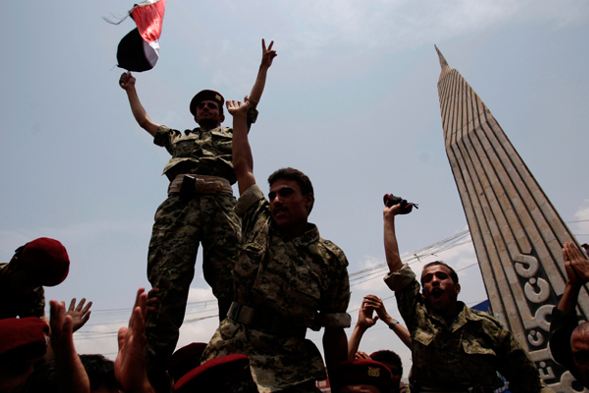 Defected soldiers salute during a protest demanding the resignation of Yemen's President Ali Abdullah Saleh in Sanaa, Yemen, Sunday July 31, 2011