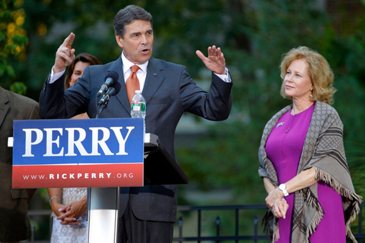 U.S. Republican presidential candidate Texas Governor Rick Perry speaks as his wife Anita (R) looks on   (Brian Snyder / Reuters)
