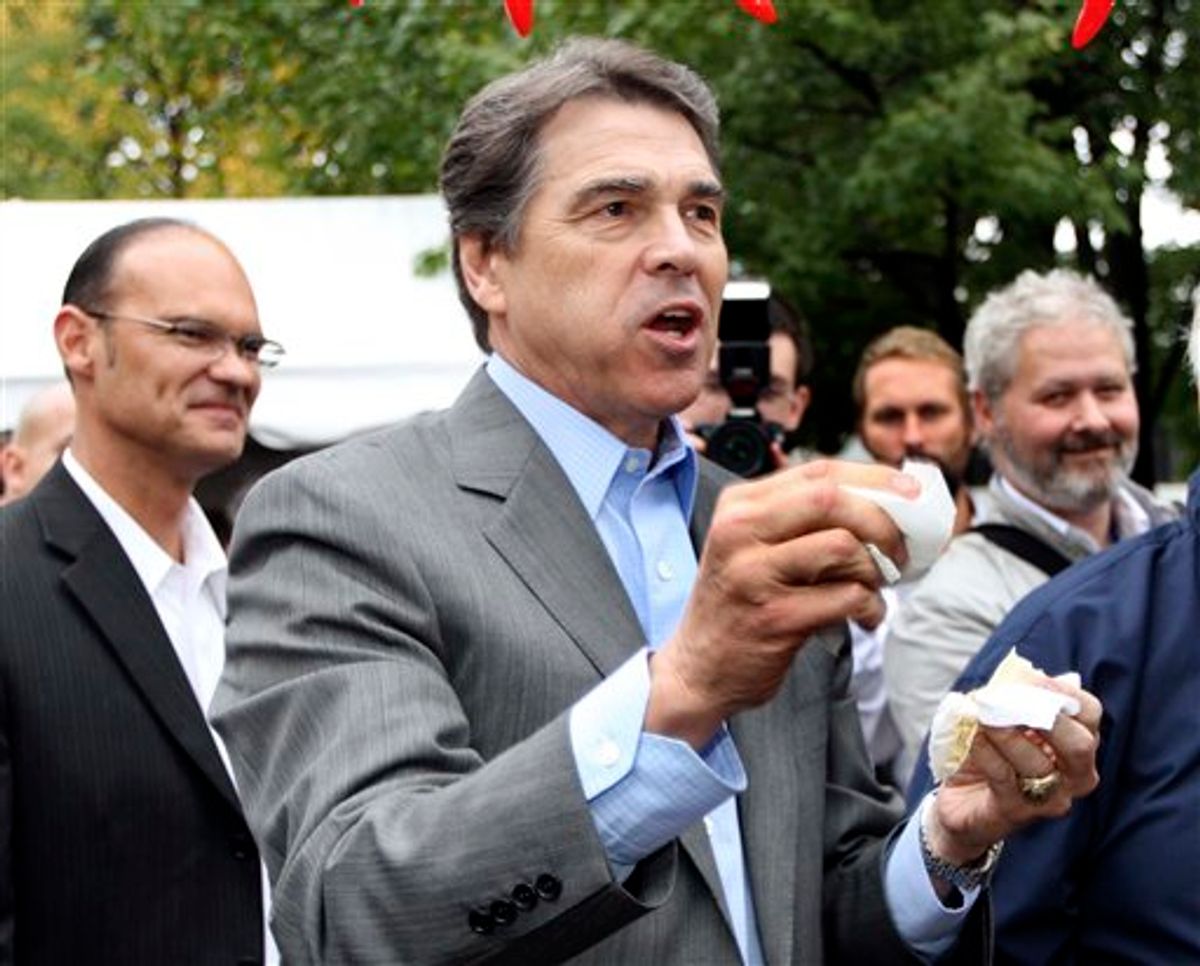 Republican presidential candidate, Texas Gov. Rick Perry reacts after taking a bite of chili during a campaign stop a the Chili Festival Saturday, Oct. 1, 2011, in Manchester, N.H. (AP Photo/Jim Cole)  (AP)