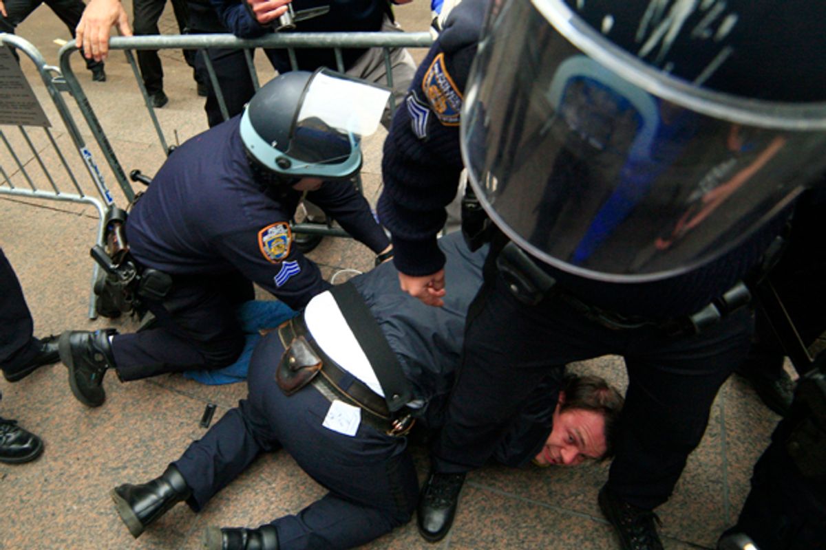 New York City police officers arrest a protestor affiliated with the Occupy Wall Street movement as he tries to return to Zuccotti Park, in New York November 15, 2011.          (Eduardo Munoz / Reuters)