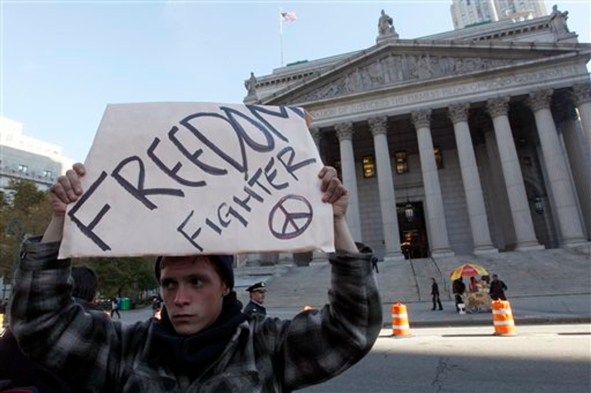 An Occupy Wall Street protester marches past New York's Supreme Court building to support his friend who was arrested Thursday, Friday, Nov. 4, 2011   (AP Photo/Mary Altaffer)