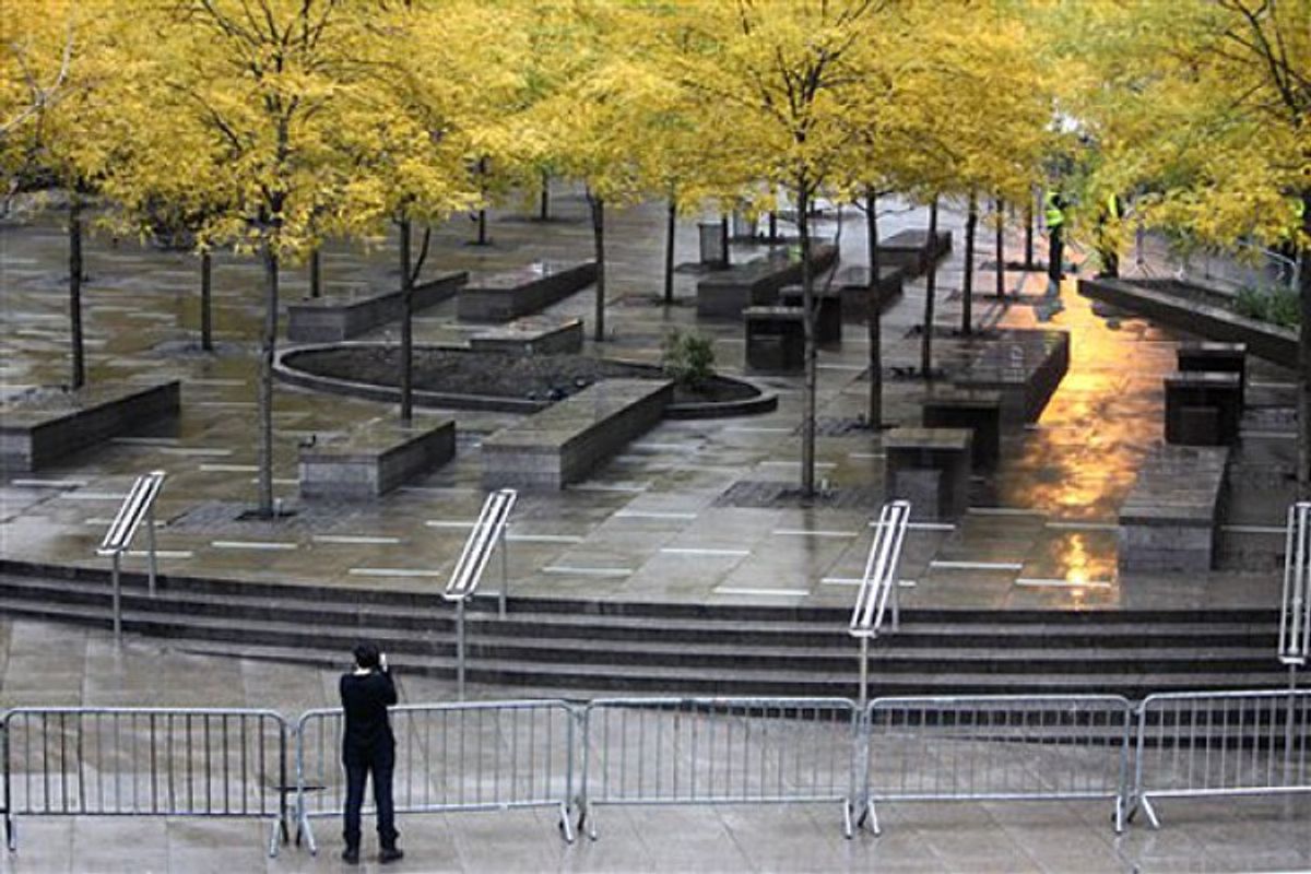 A pedestrian takes a picture of an empty and closed Zuccotti Park in New York, Nov. 15, 2011.           (AP/Seth Wenig)